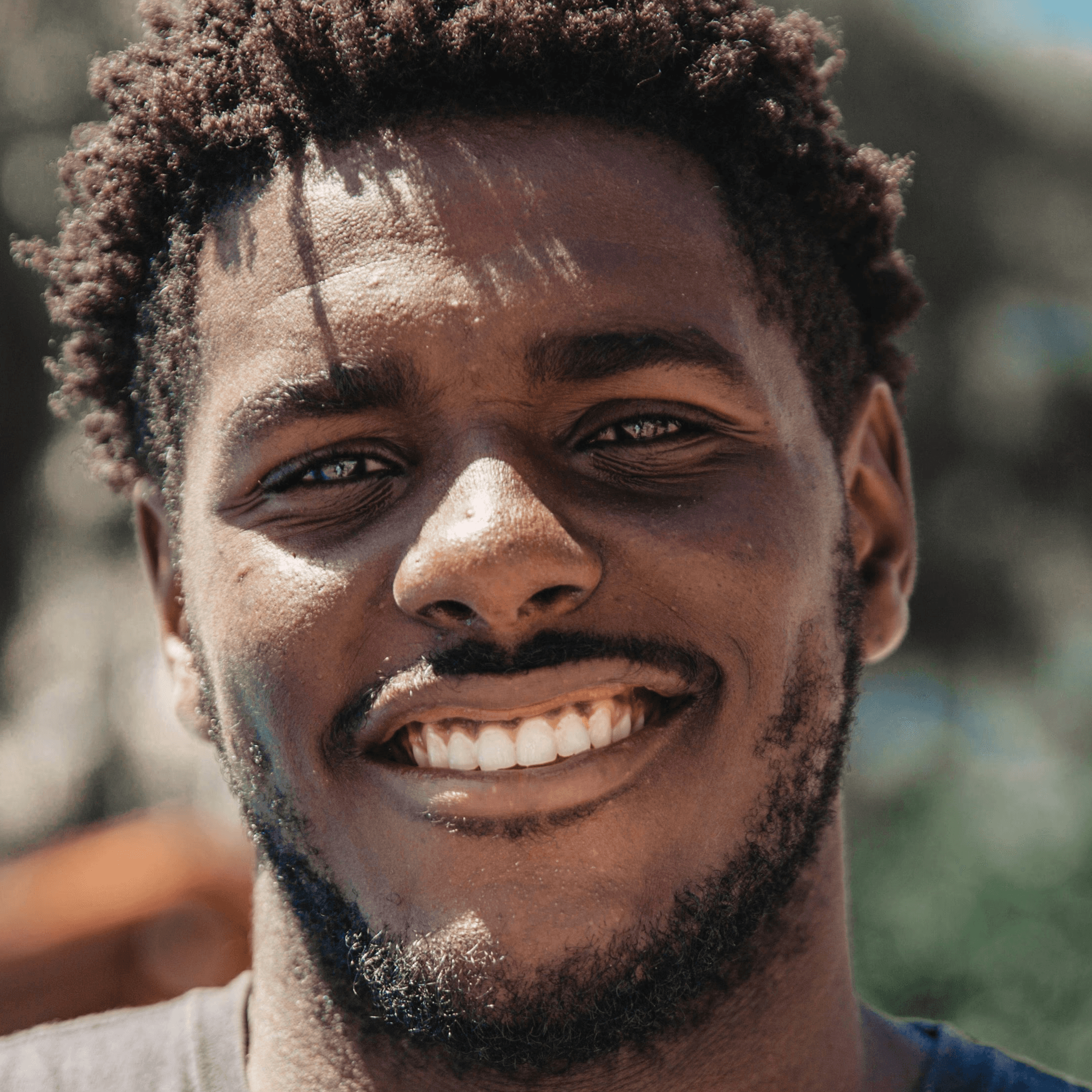 selective focus of man smiling during daytime