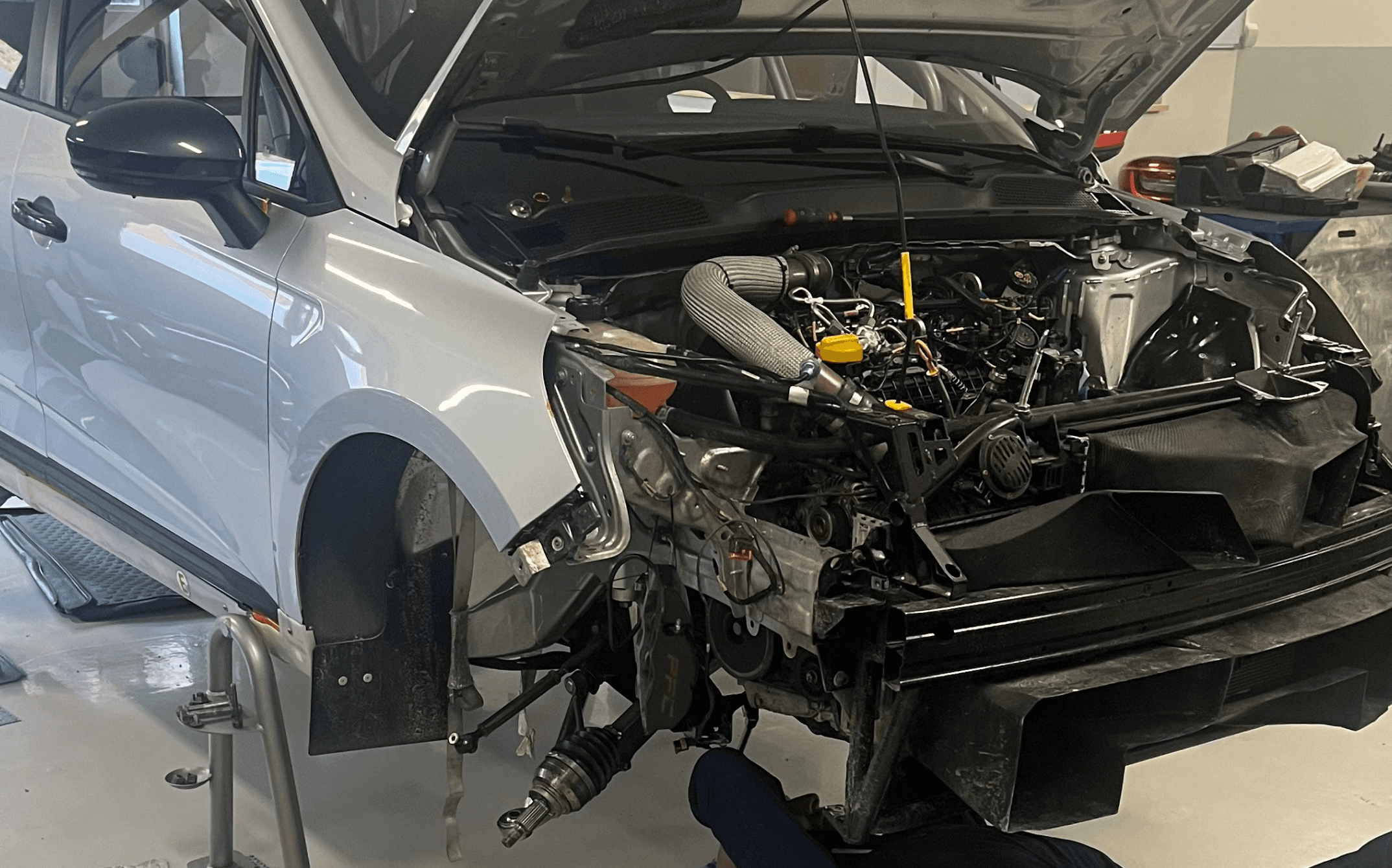 Race car being prepared in the workshop before a competition event.