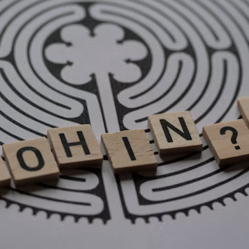 a close up of scrabble tiles with words saying who's in?