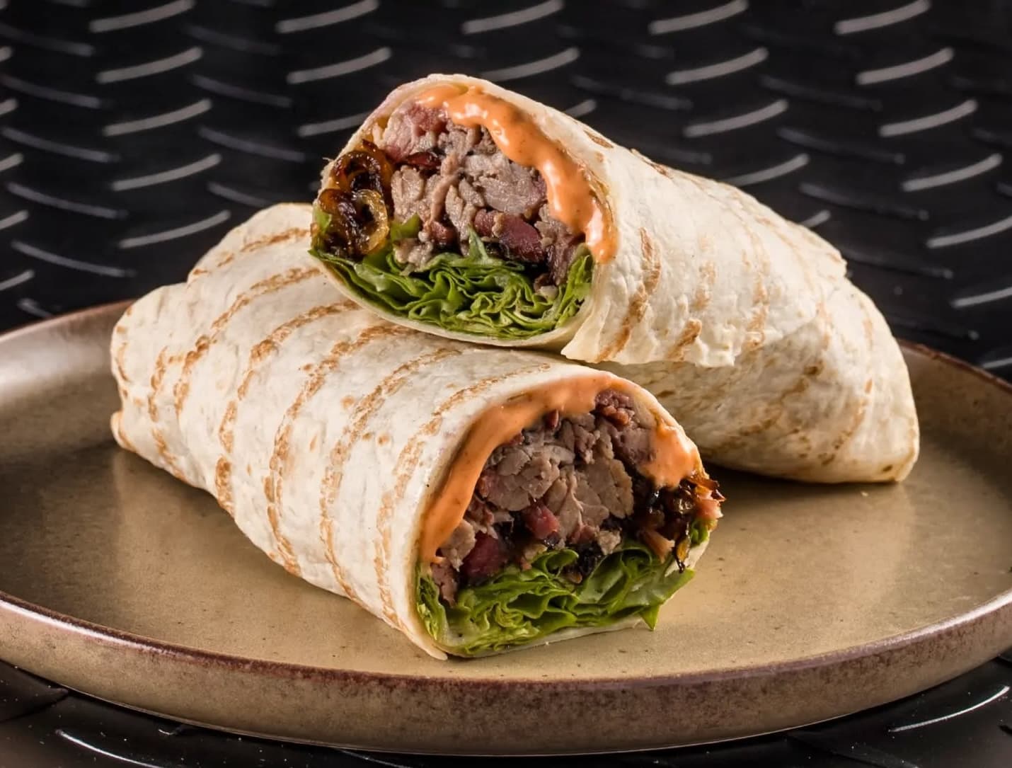 BBQ restaurant dubai showcasing a Texas-style brisket wrap filled with slow-smoked beef, wrapped fresh and packed.