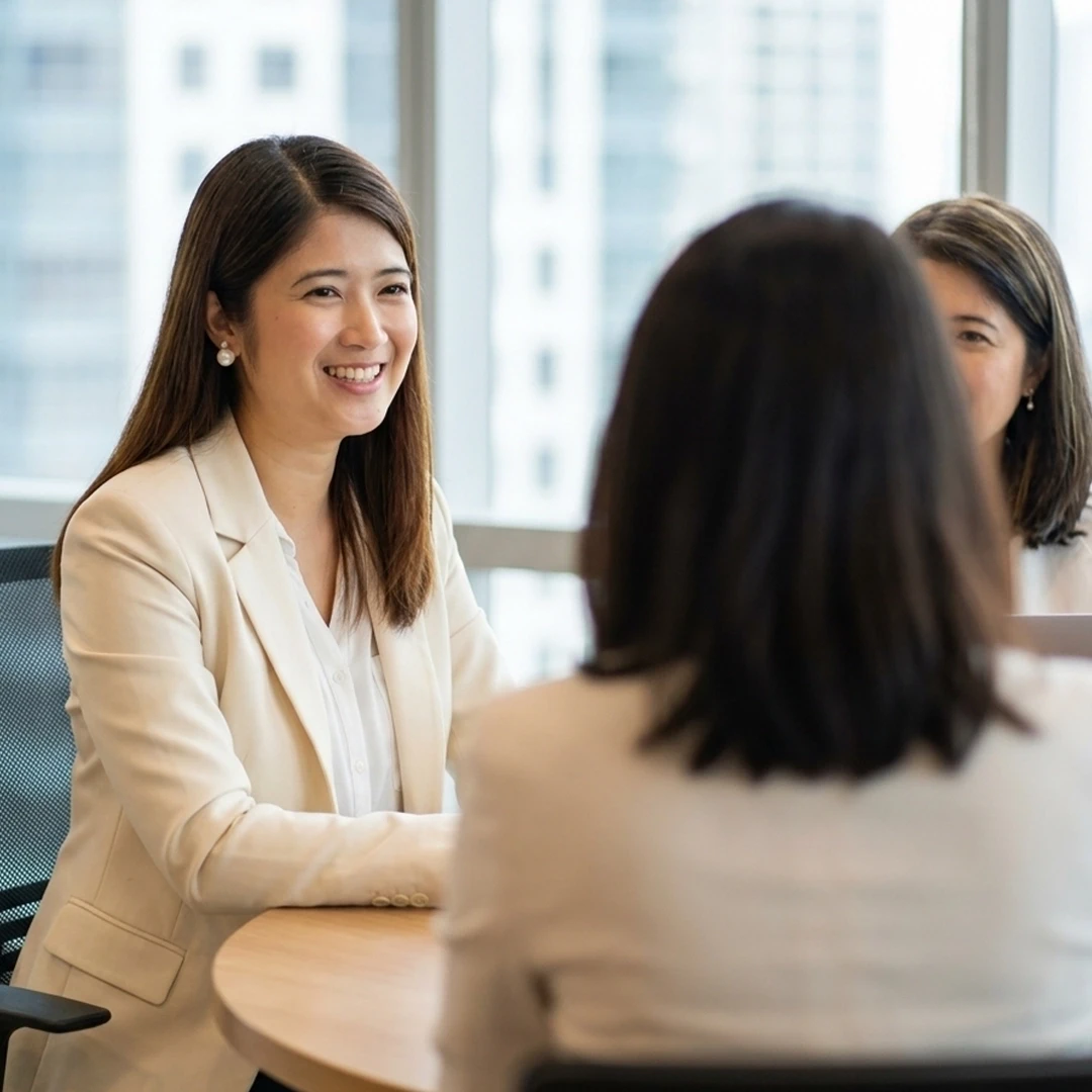 A Gladness team member smiling while reviewing work on a tablet