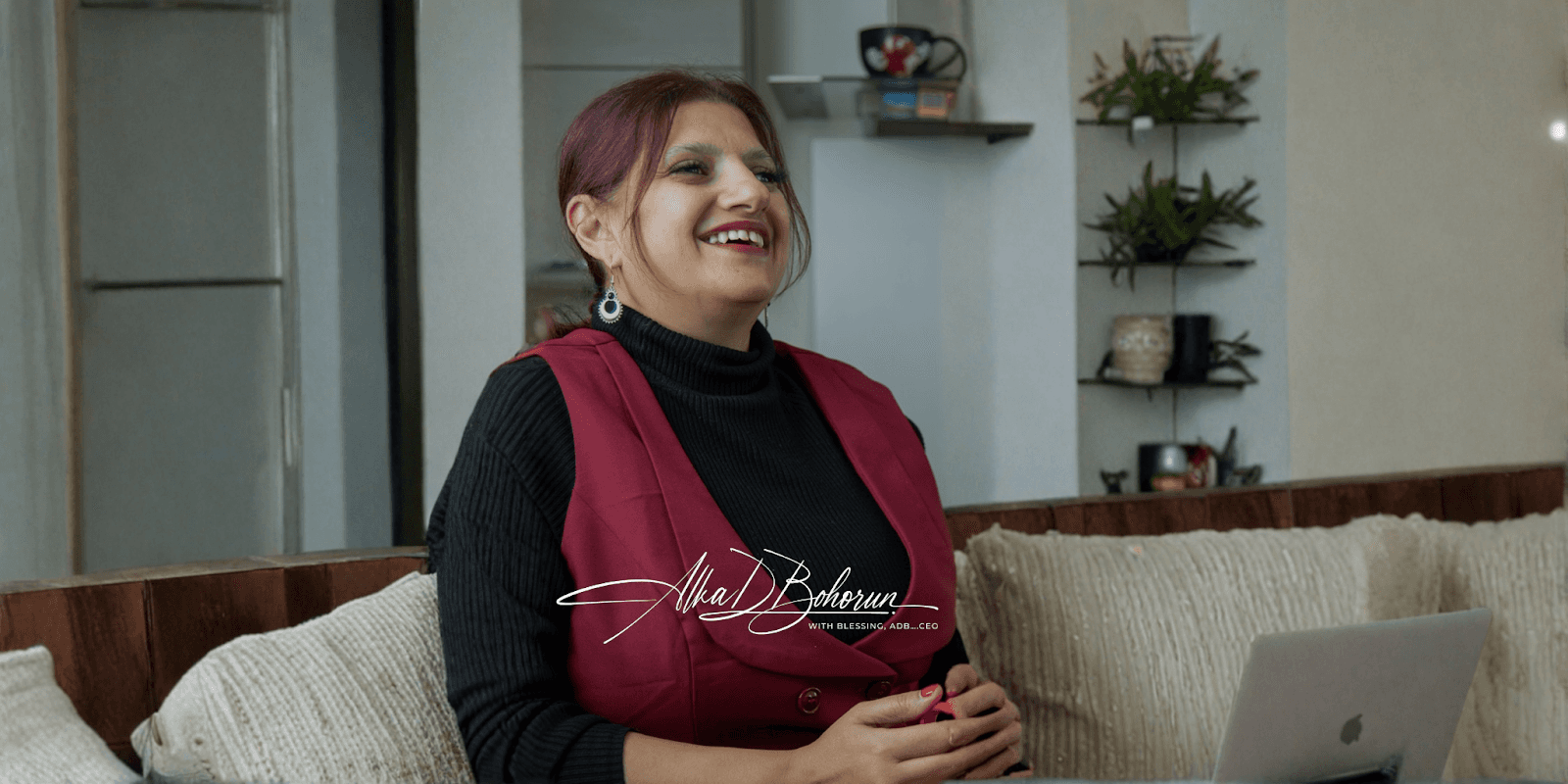 Alka Bohorun smiling while seated, reflecting her leadership in Bh40's global impact, empowering communities with limited resources.