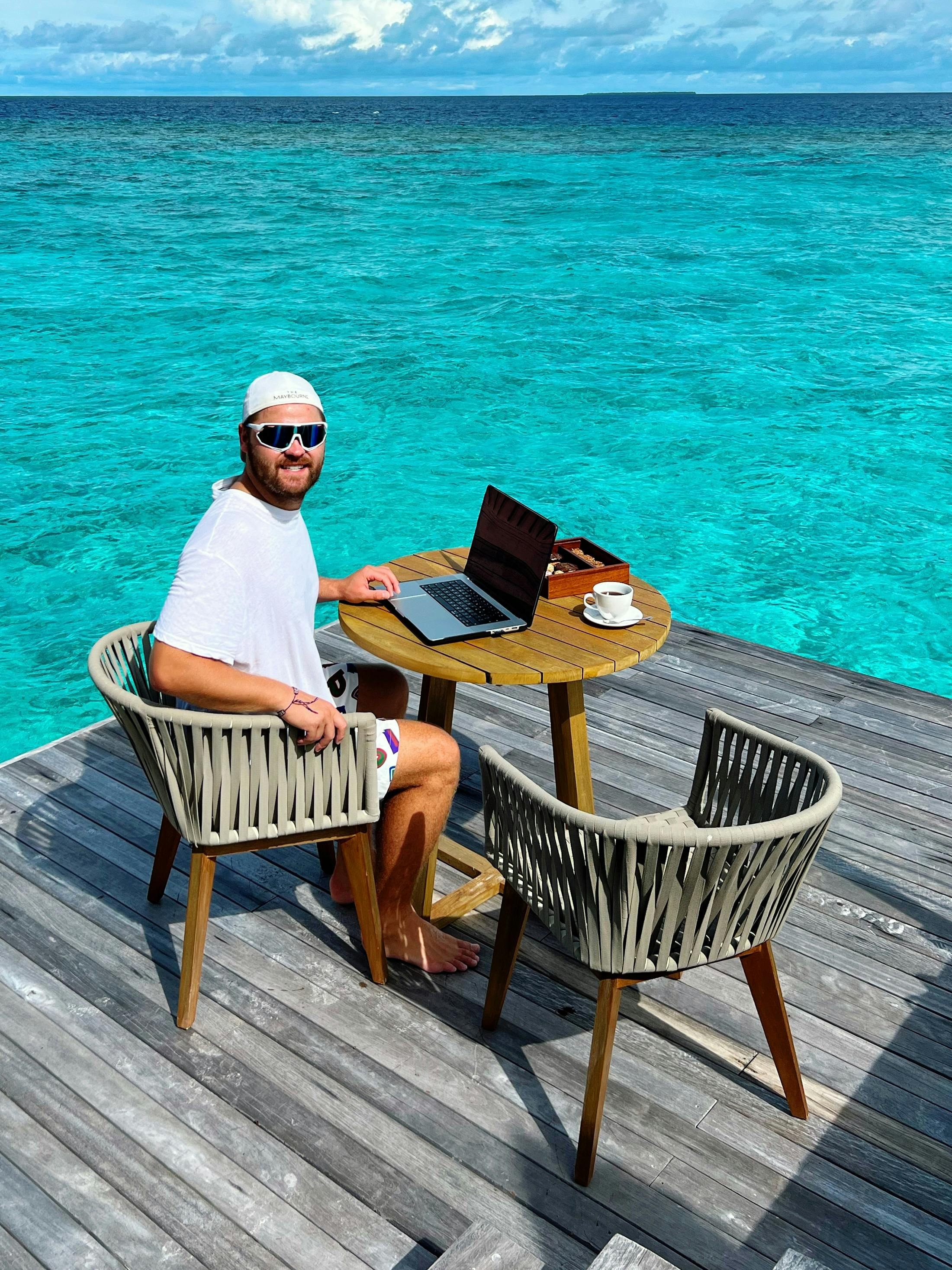 Close-up of a dark green leaf showing its textured surface and central vein against a muted background.