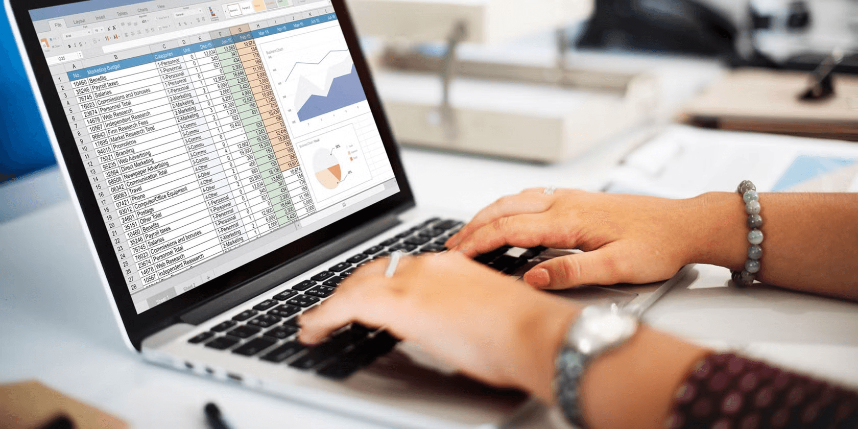 Person working on budget spreadsheet - How to Use Forecast in Excel