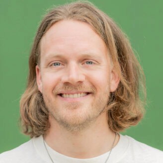 A person smiling and looking back.