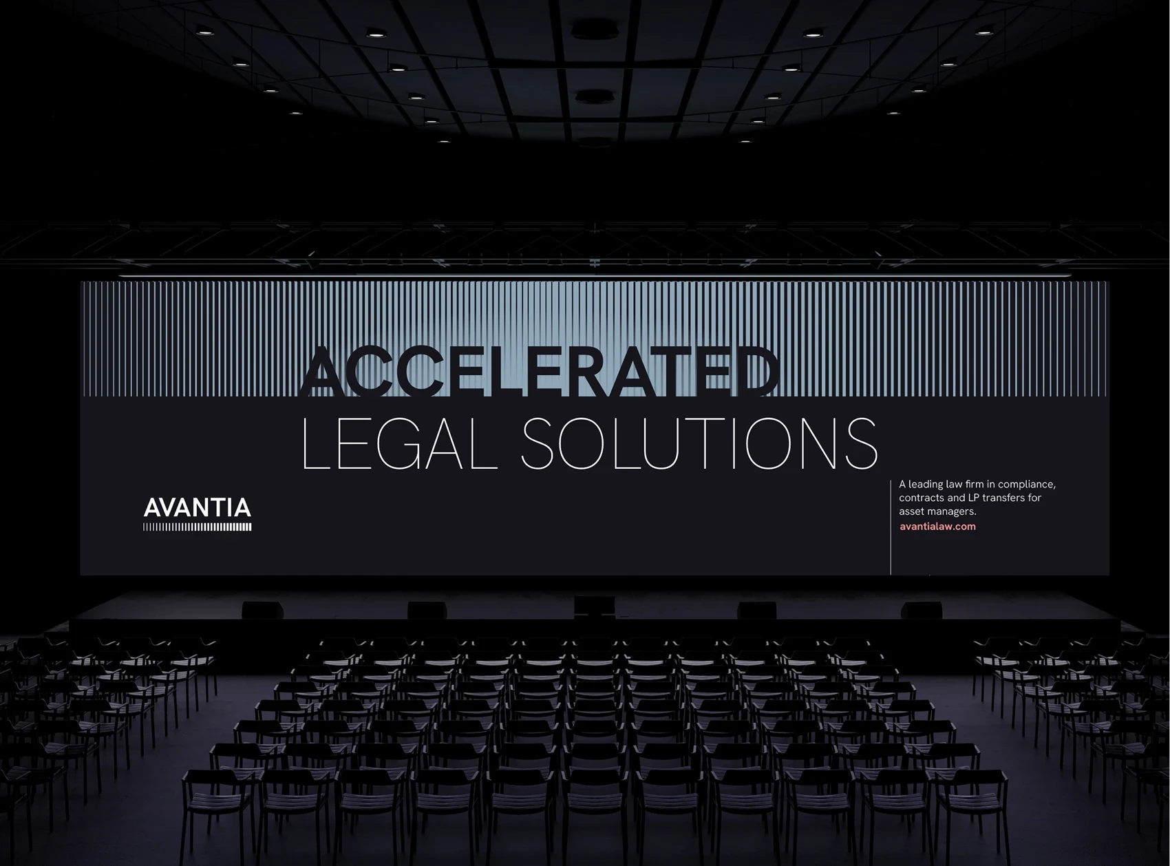 Large conference stage backdrop featuring Avantia branding. The display reads ‘ACCELERATED LEGAL SOLUTIONS’ in large type, with striped vertical patterns across the top. The lower right includes Avantia’s website and a short description. Rows of chairs are arranged in the foreground.