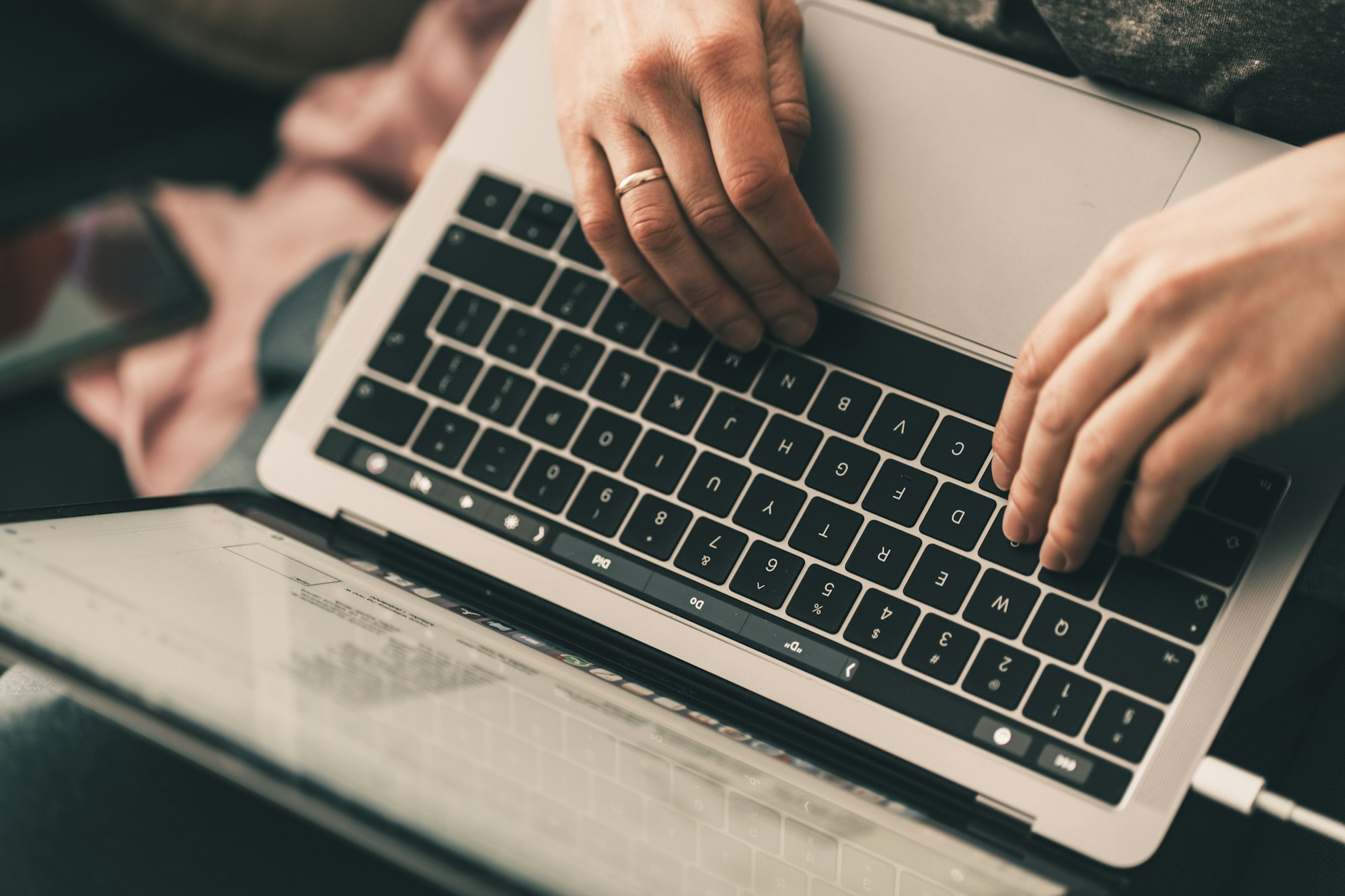 Hands typing on a laptop keyboard
