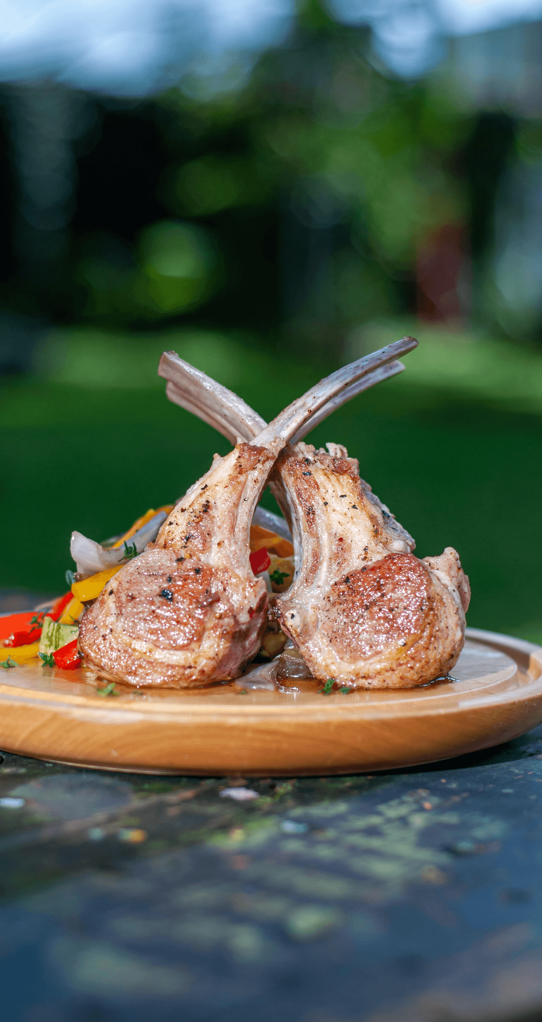 a wooden plate topped with meat on top of a wooden table