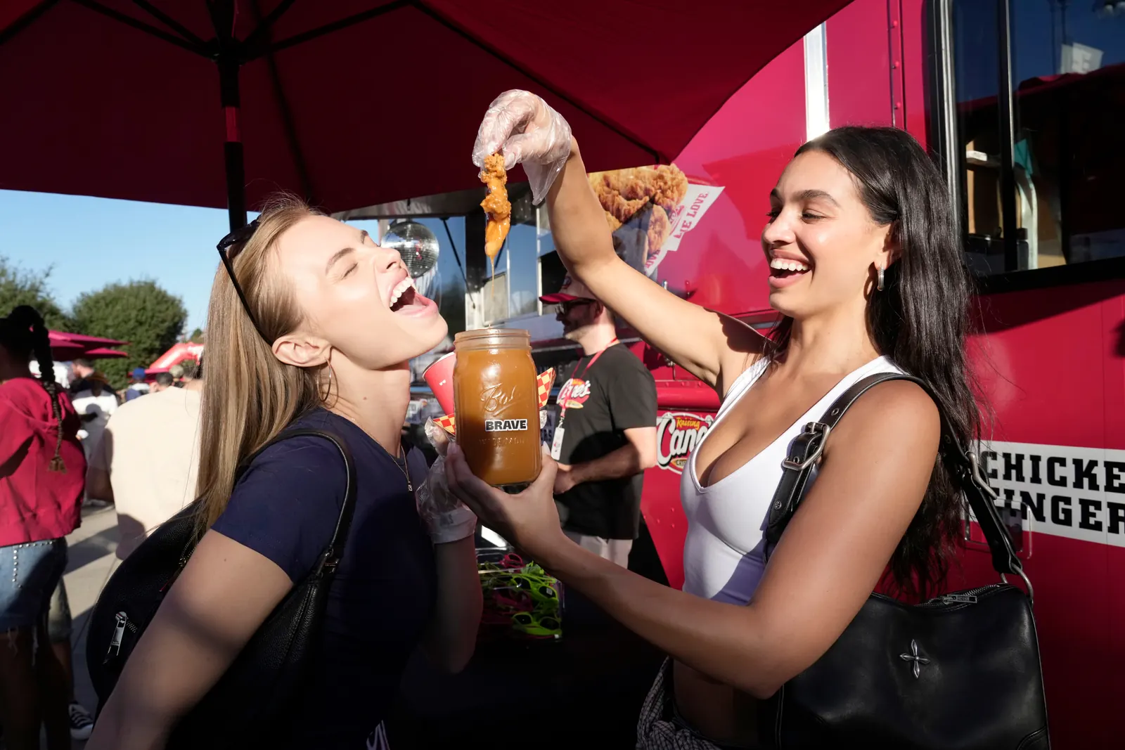 Festivalgoers sharing a chicken tender at a previous TenderFest; archival photograph