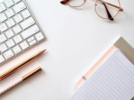White workspace with keyboard and notebook