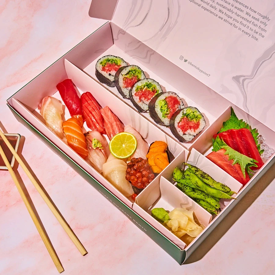 Assorted sushi and sashimi in a Bento by Point Seven box