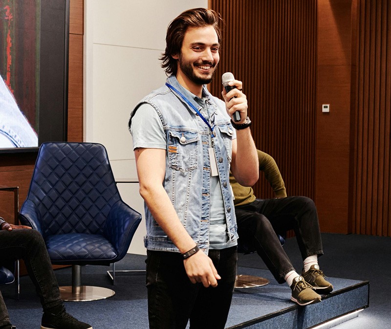 A guy holding mic with smile in his face