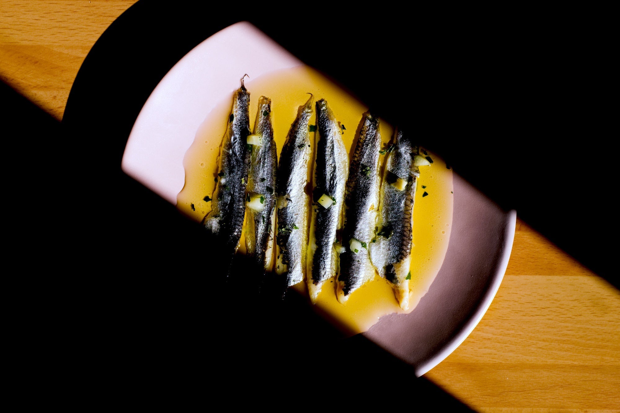Plated dish of grilled sardines with Kurio organic olive oil