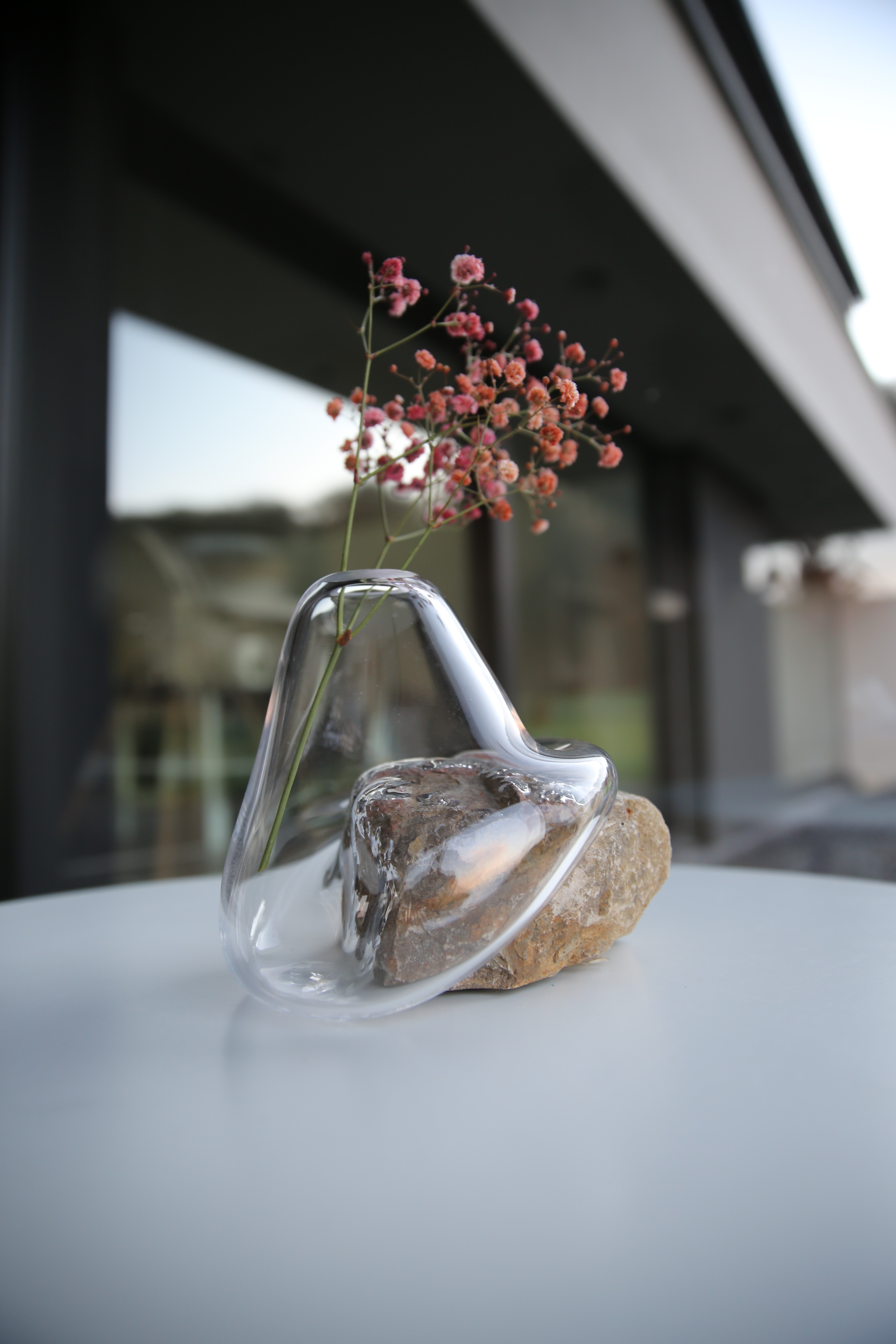 A scene of a table filled with swatch books overlooking a shelf filled with ceramic vases