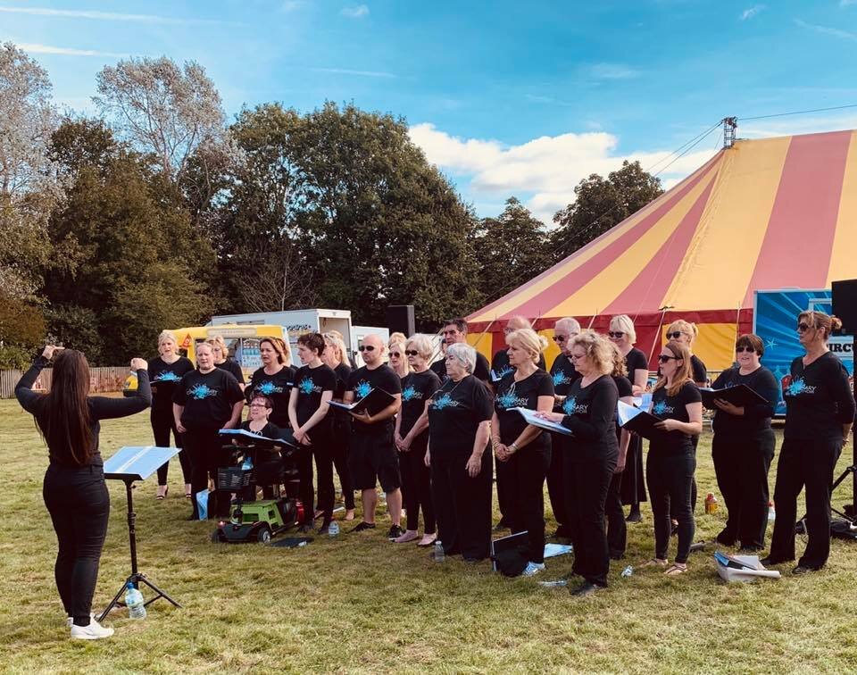 The choir singing at an outdoor community event