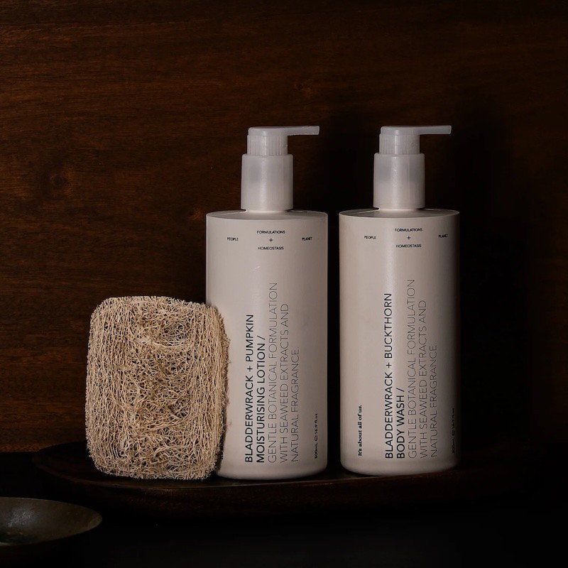 A Dulcie ritual set featuring two white 500ml VIVOMER bottles. The elegant matching set demonstrates how plastic-free materials can elevate the aesthetic of premium bathroom products.