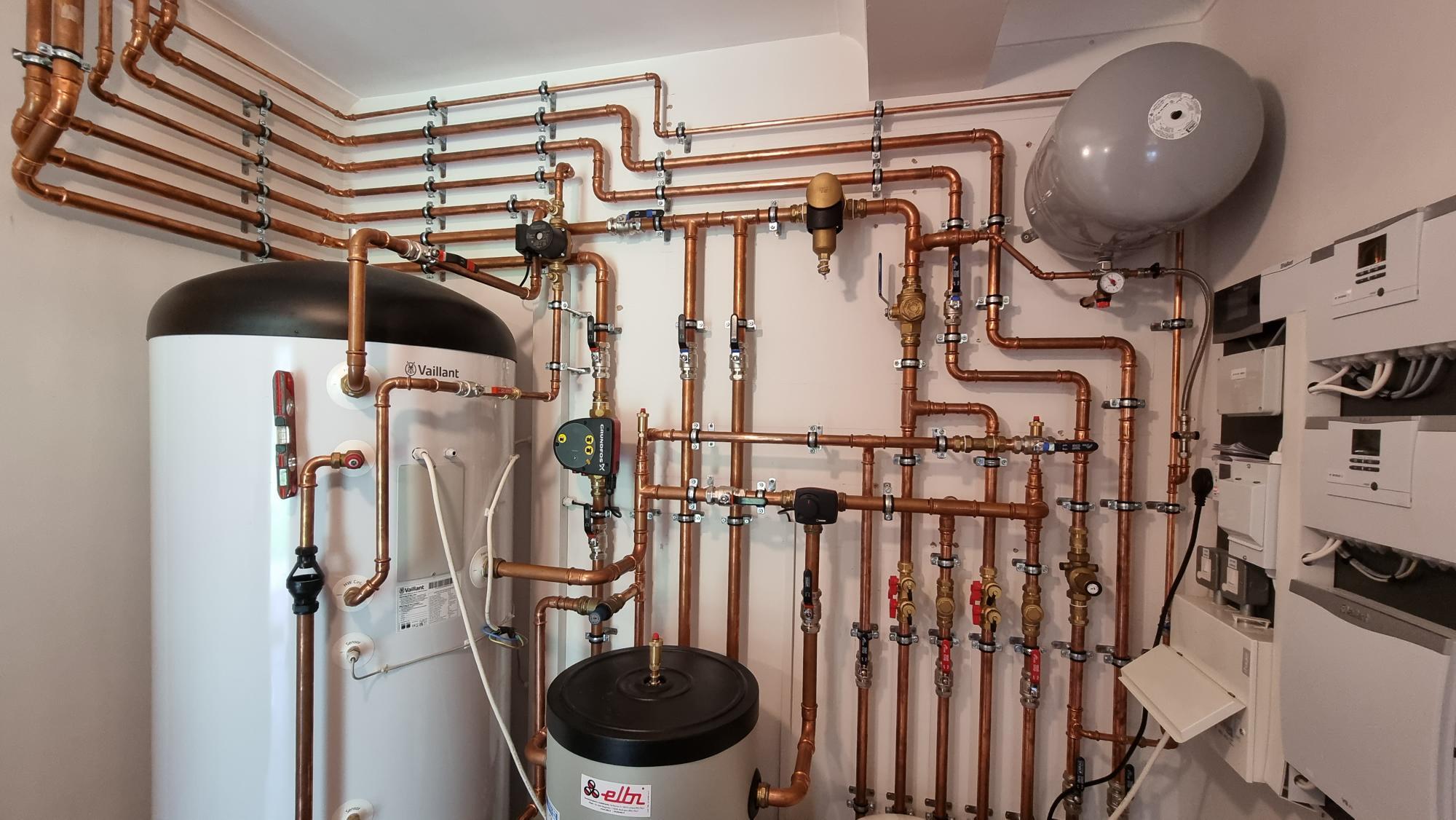Expansion vessel fitted in a large plant room on a UK underfloor heating system — the type of component whose absence caused repeated pressure loss on a West Yorkshire heat pump installation.
