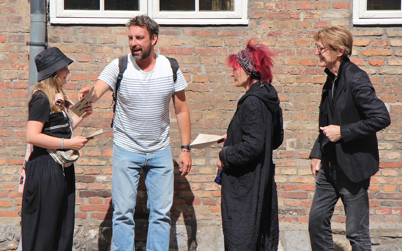 Participants discussing clues during a murder mystery at Christiansborg Palace.