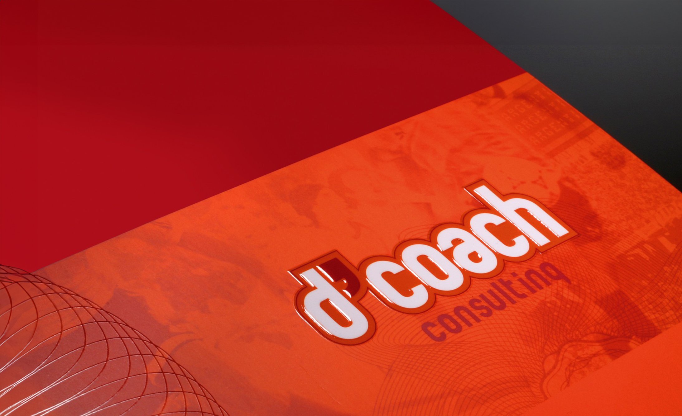 Bold red and orange geometric background featuring the text "d'coach consulting" in white and red. A dynamic, modern, and professional tone.
