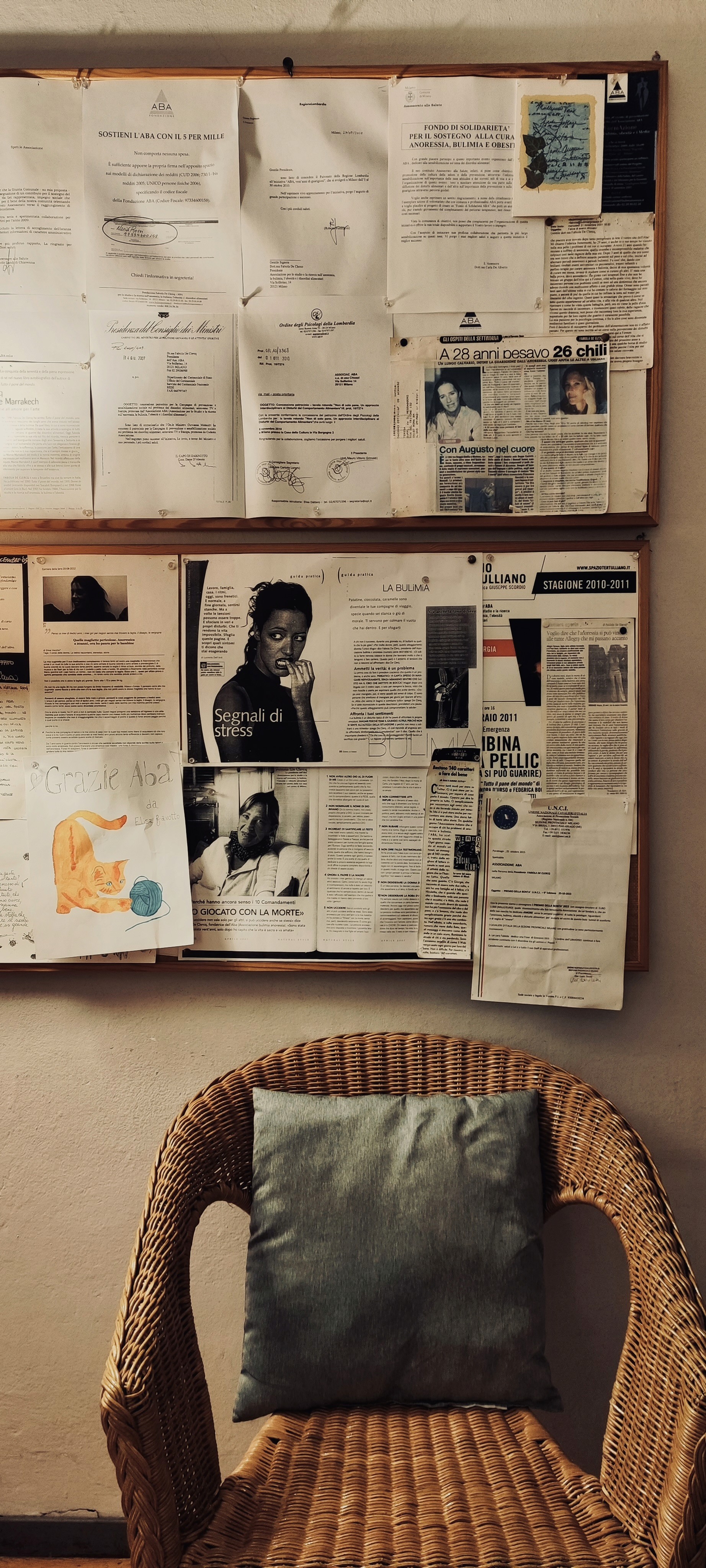 Smiling man wearing glasses and a pink shirt, showing his arm with a bandage after vaccination.