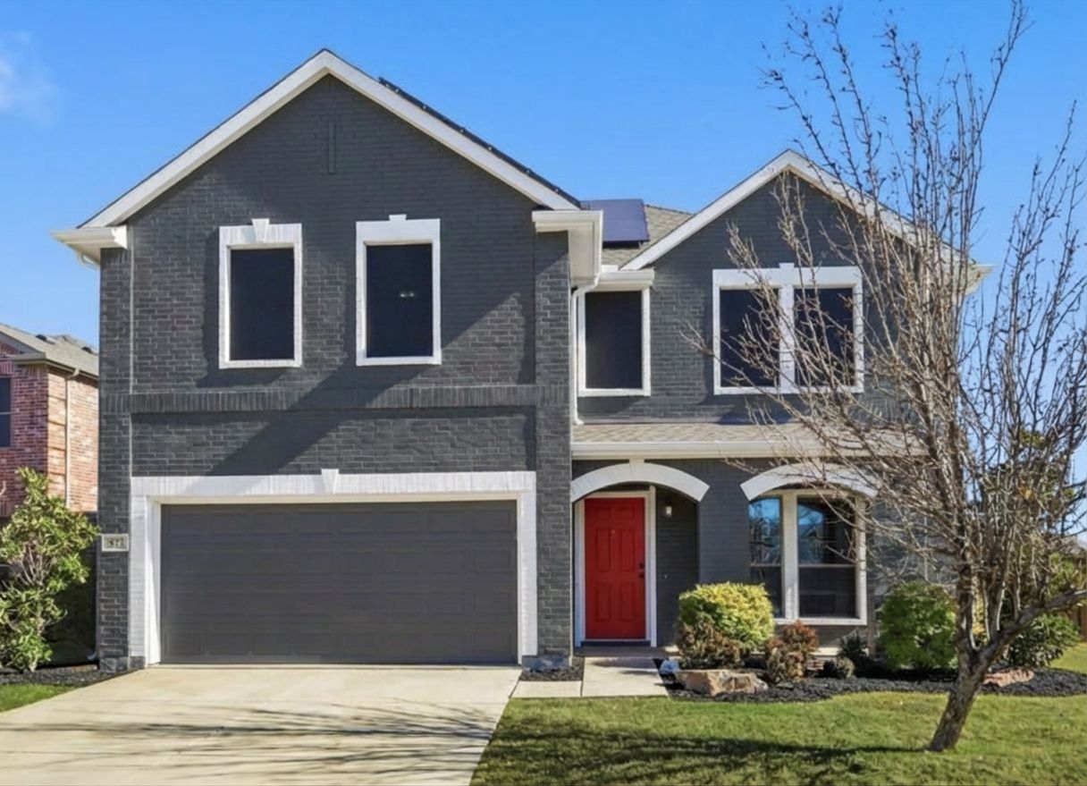 House painted charcoal gray with red front door using AI