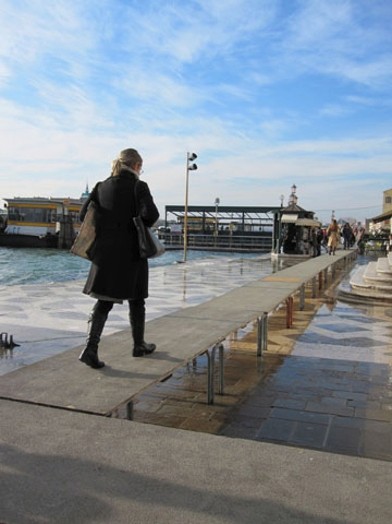 woman walking on a long pontoon in the cold season