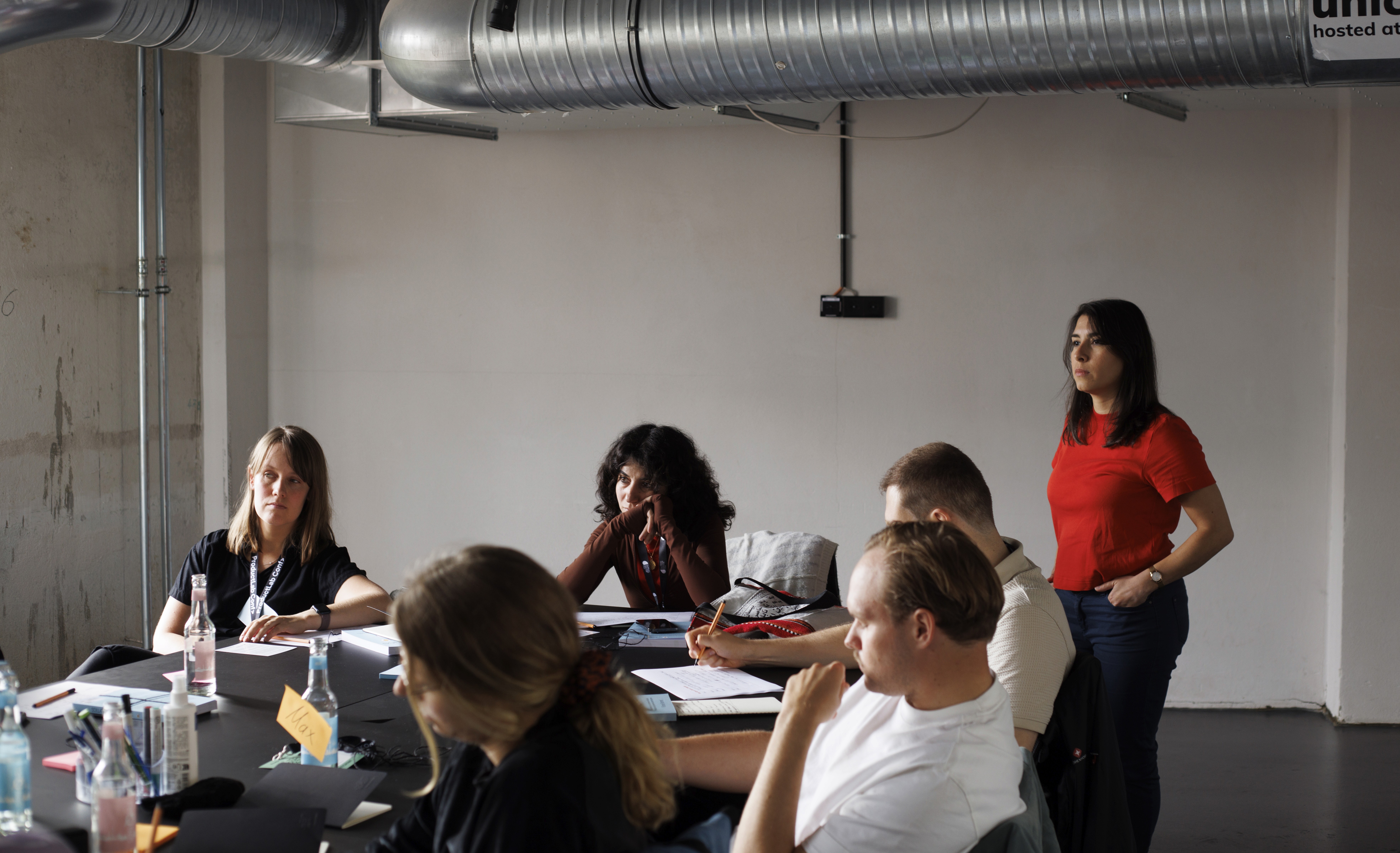 person sitting on grass and using phone