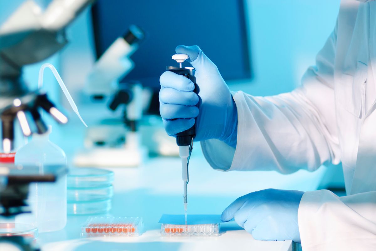 cosmetic lab technician reviewing clean beauty formulation during production