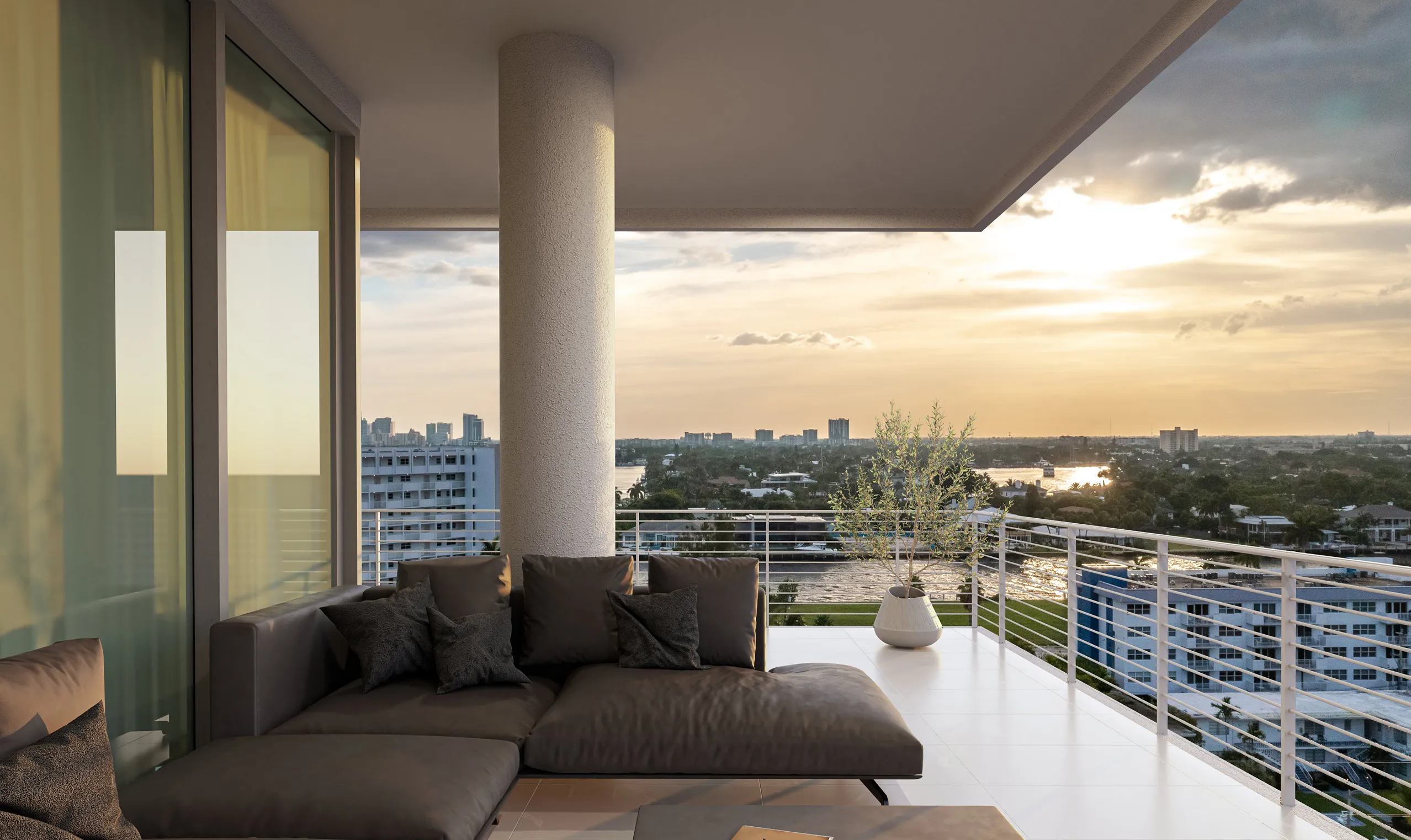 A balcony featuring a couch overlooks a vibrant city skyline under a clear blue sky.