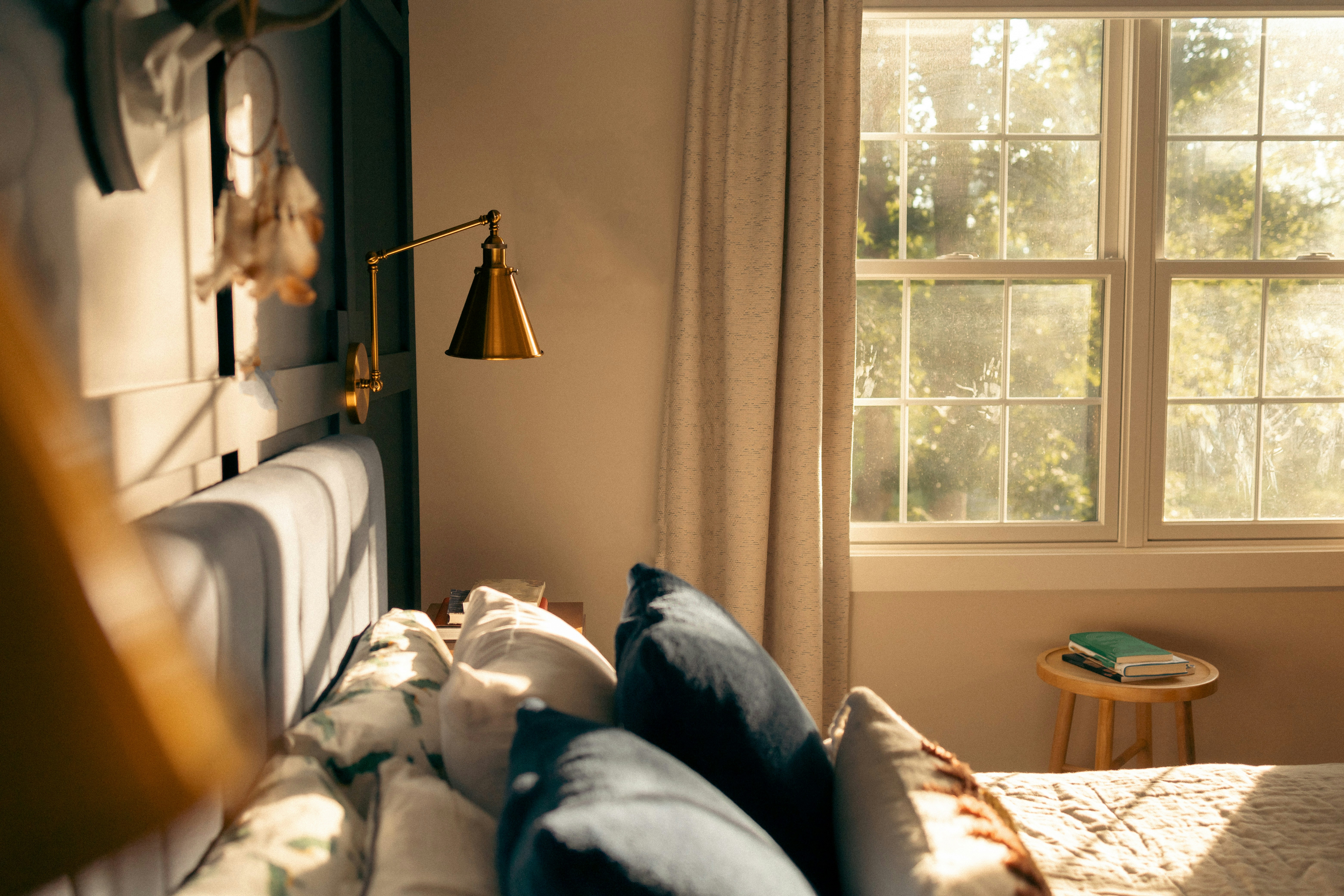 Soft light entering a bedroom through a window.