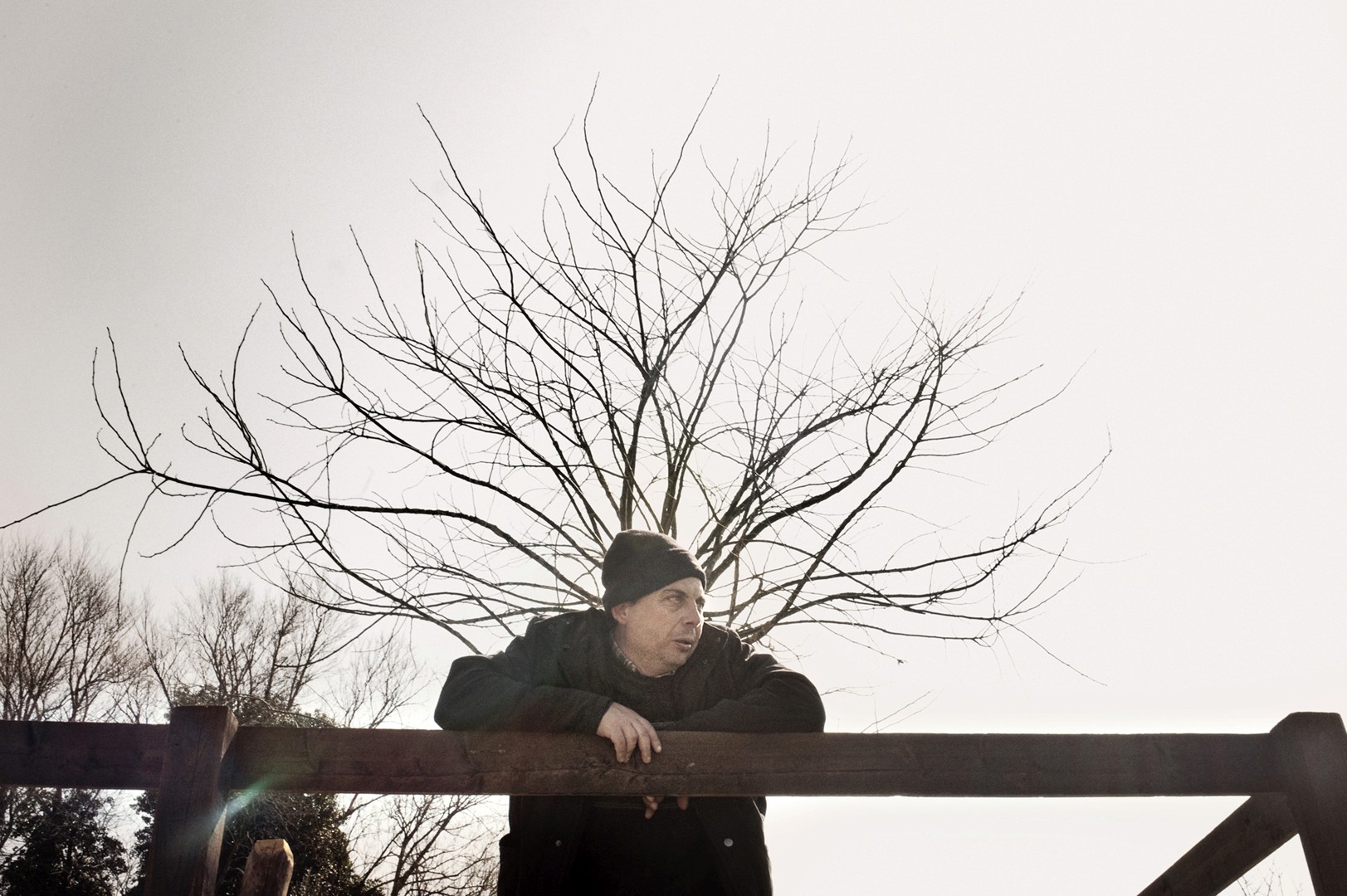 Tanya – Youth Disorder – seated on a chair in a sparse room, arm lifted with a distant expression