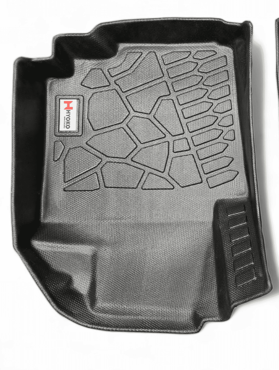 Driver-side car floor mat in black with rugged stone-textured surface and heel pad for durability and grip.