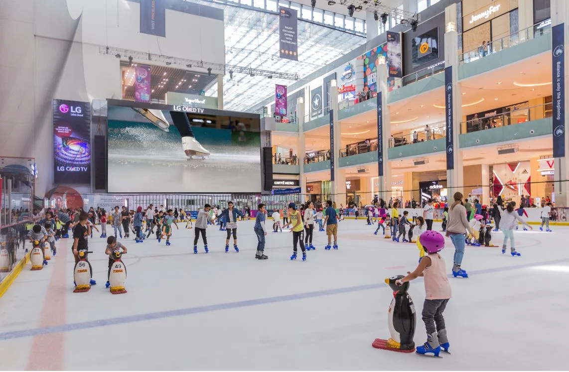 Families, tourists, and locals enjoy skating on the ice in Dubai Ice Rink. 