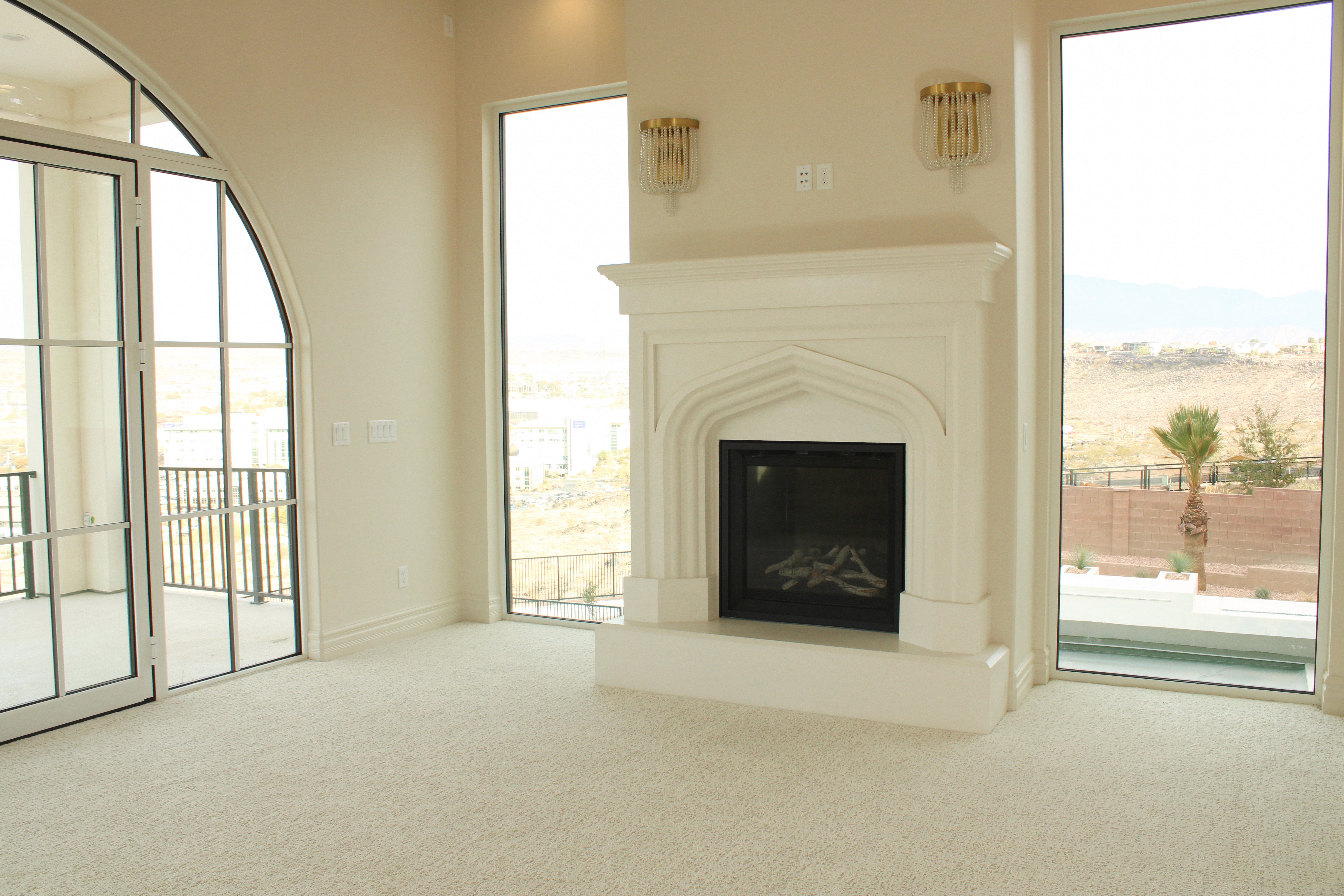 Master bedroom featuring a fireplace and bright, spacious design in a St. George, Utah home.