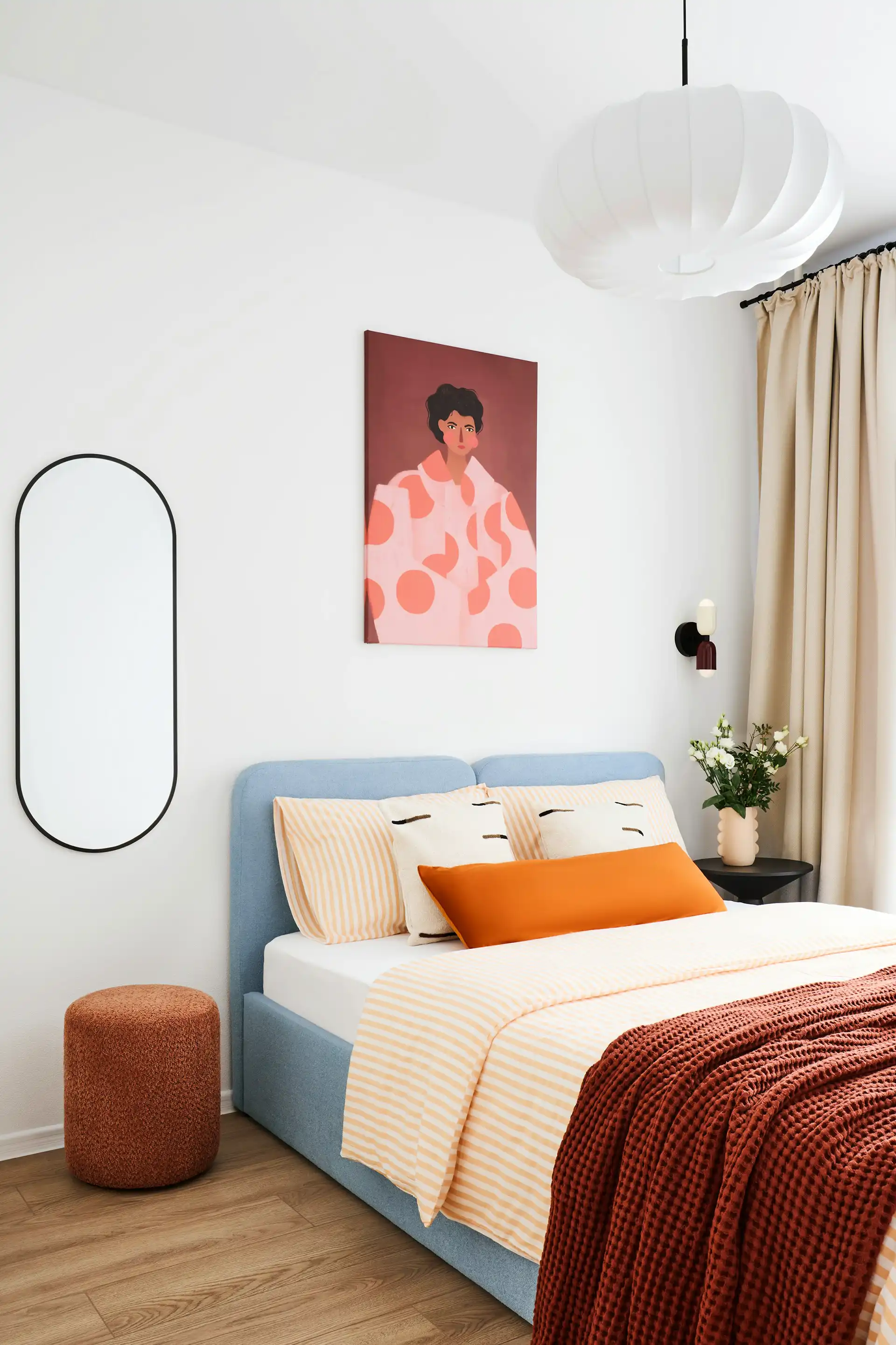 Modern bedroom with a neatly made bed, soft lighting, and minimal decor