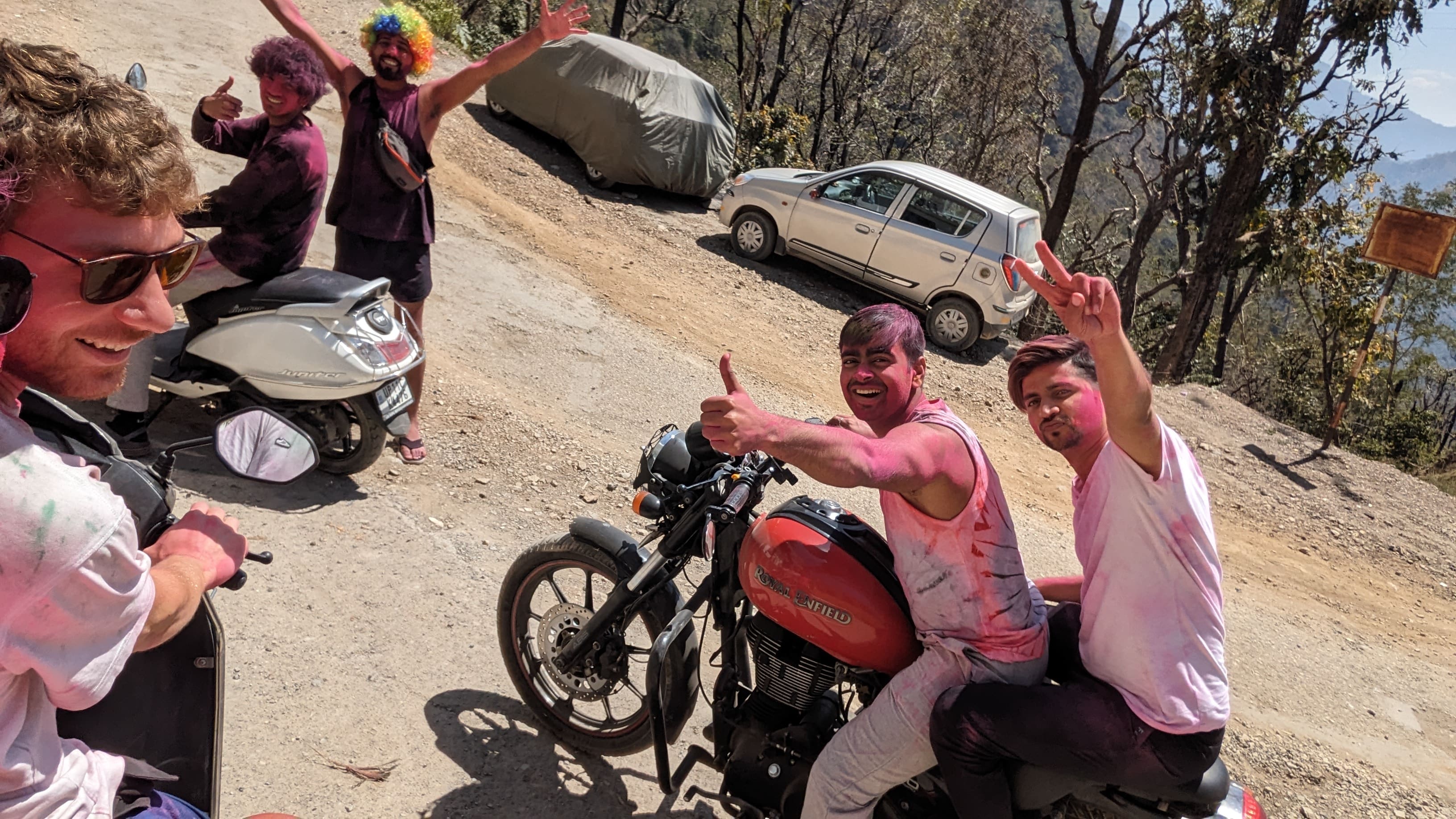 Friends reunion with scooters and bikes before going to a party celebrating Holi festival of colors in Rishikesh (India)