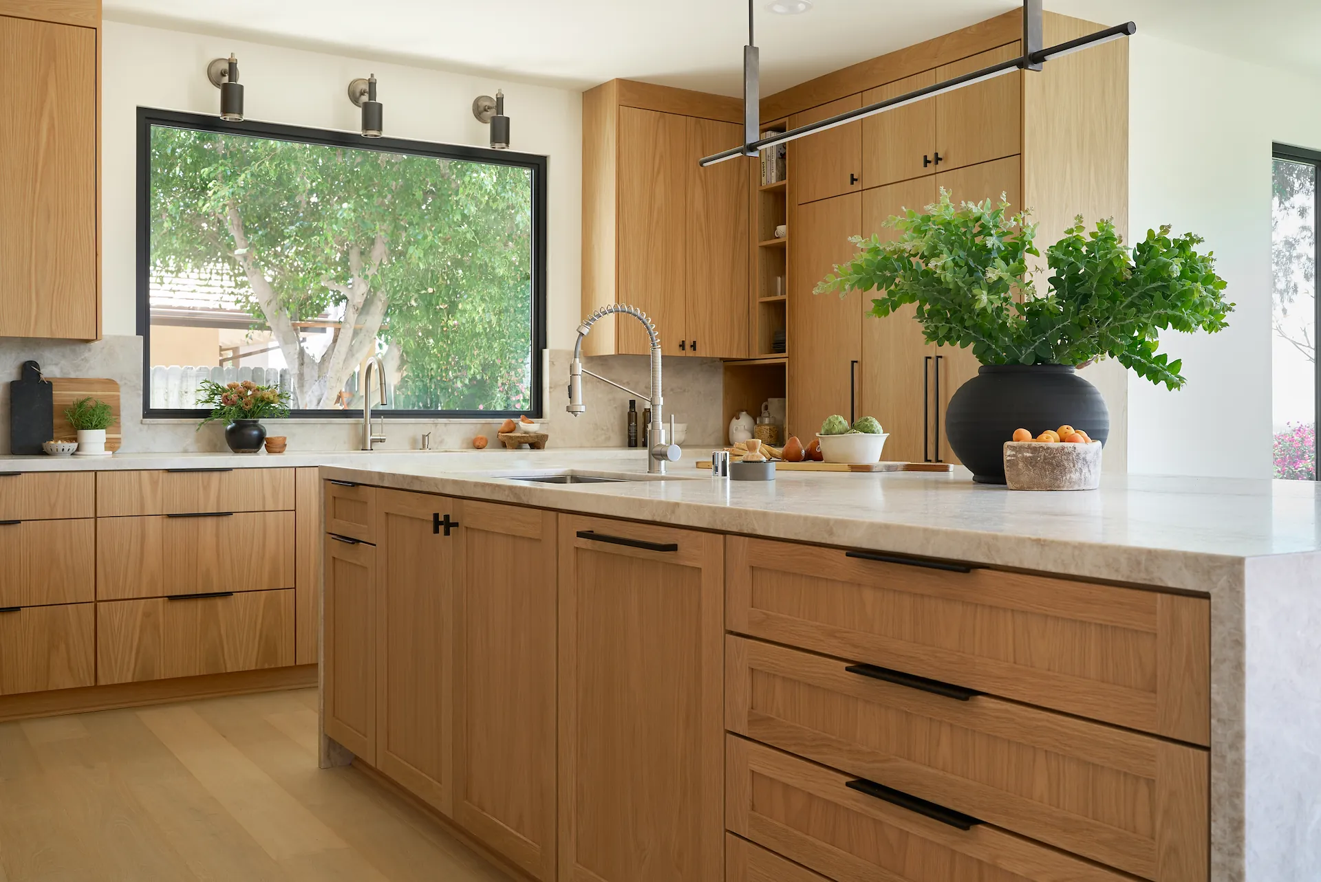 Angle one view of the kitchen island, showcasing its functionality in the Fullerton kitchen. Photo by Todd Huge.