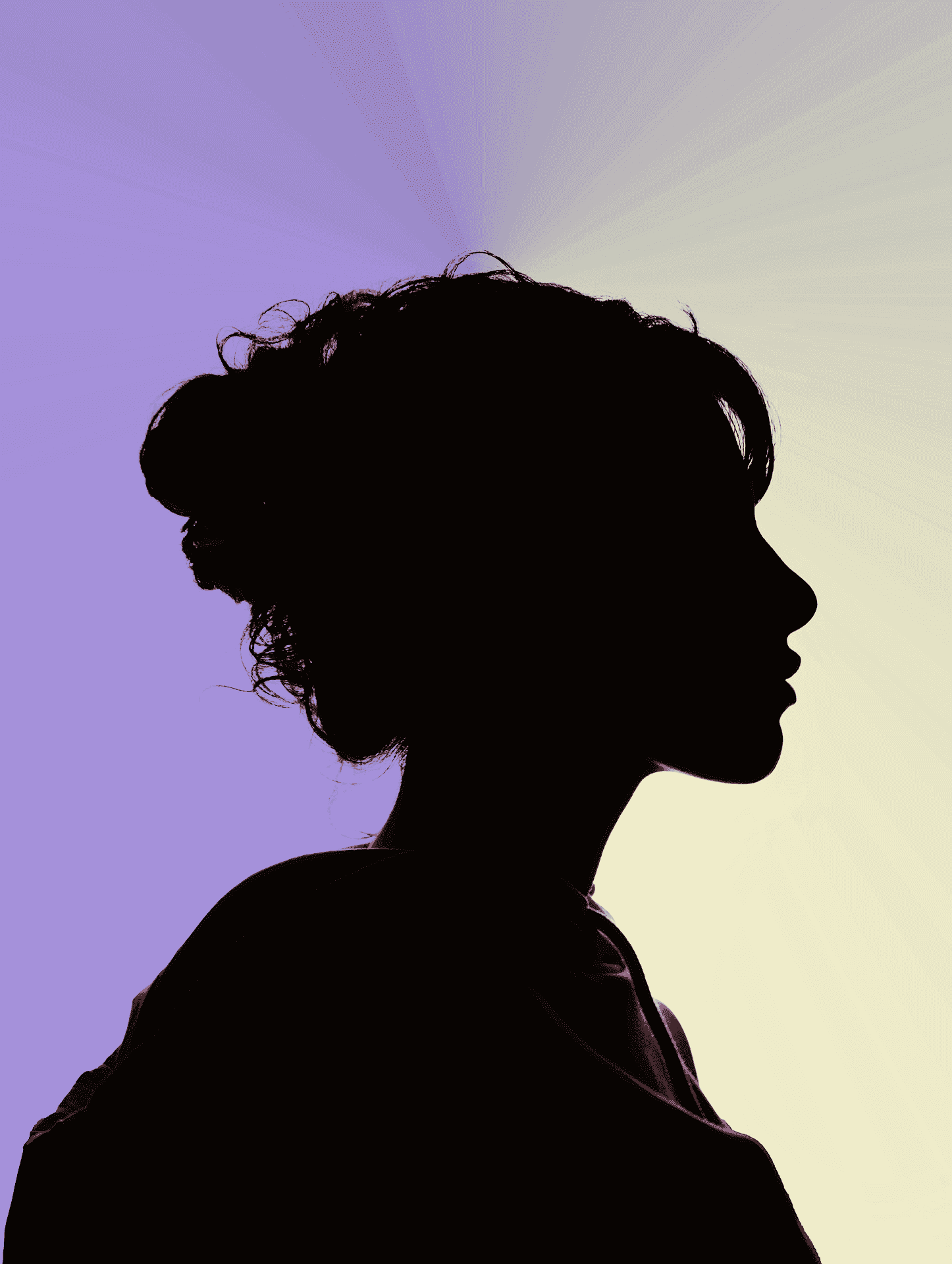 Woman in a blue blouse smiling gently in front of a softly lit backdrop, with abstract flowing light patterns creating a serene, professional atmosphere.