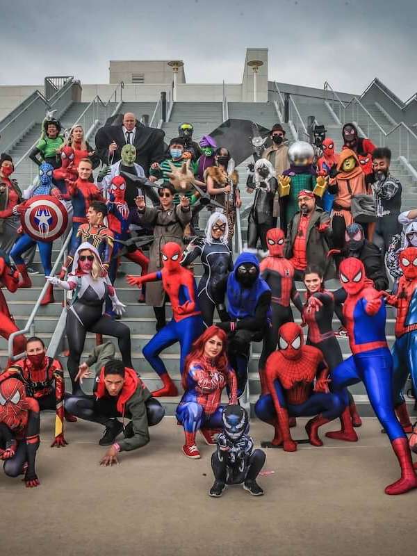 Fans in Marvel cosplay at a convention.