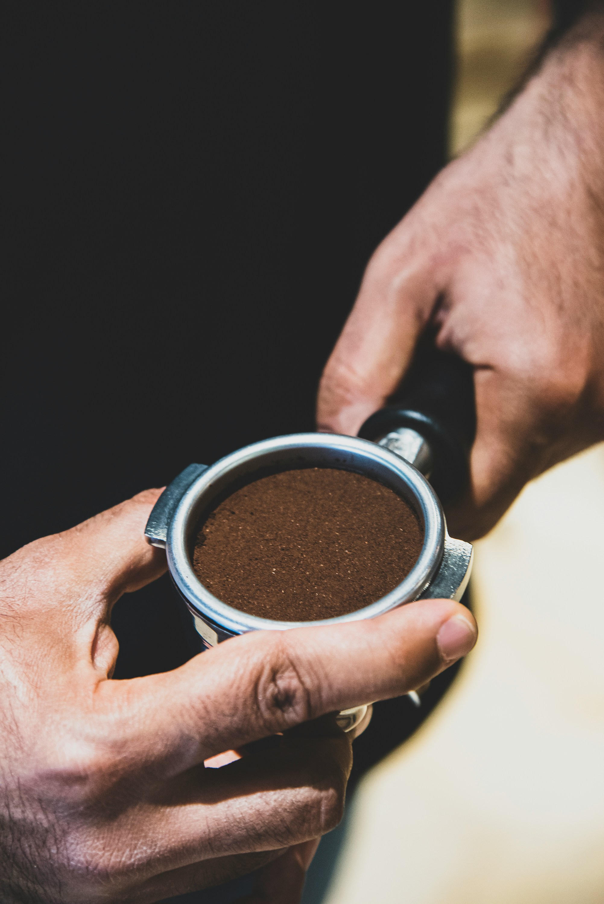 a person holding a cup of coffee in their hands