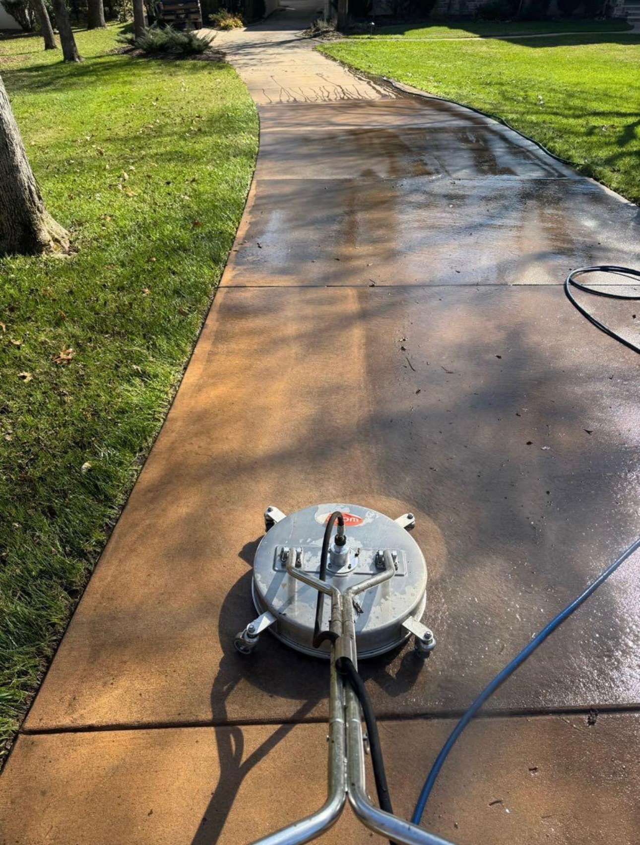 Pressure washer cleaning driveway
