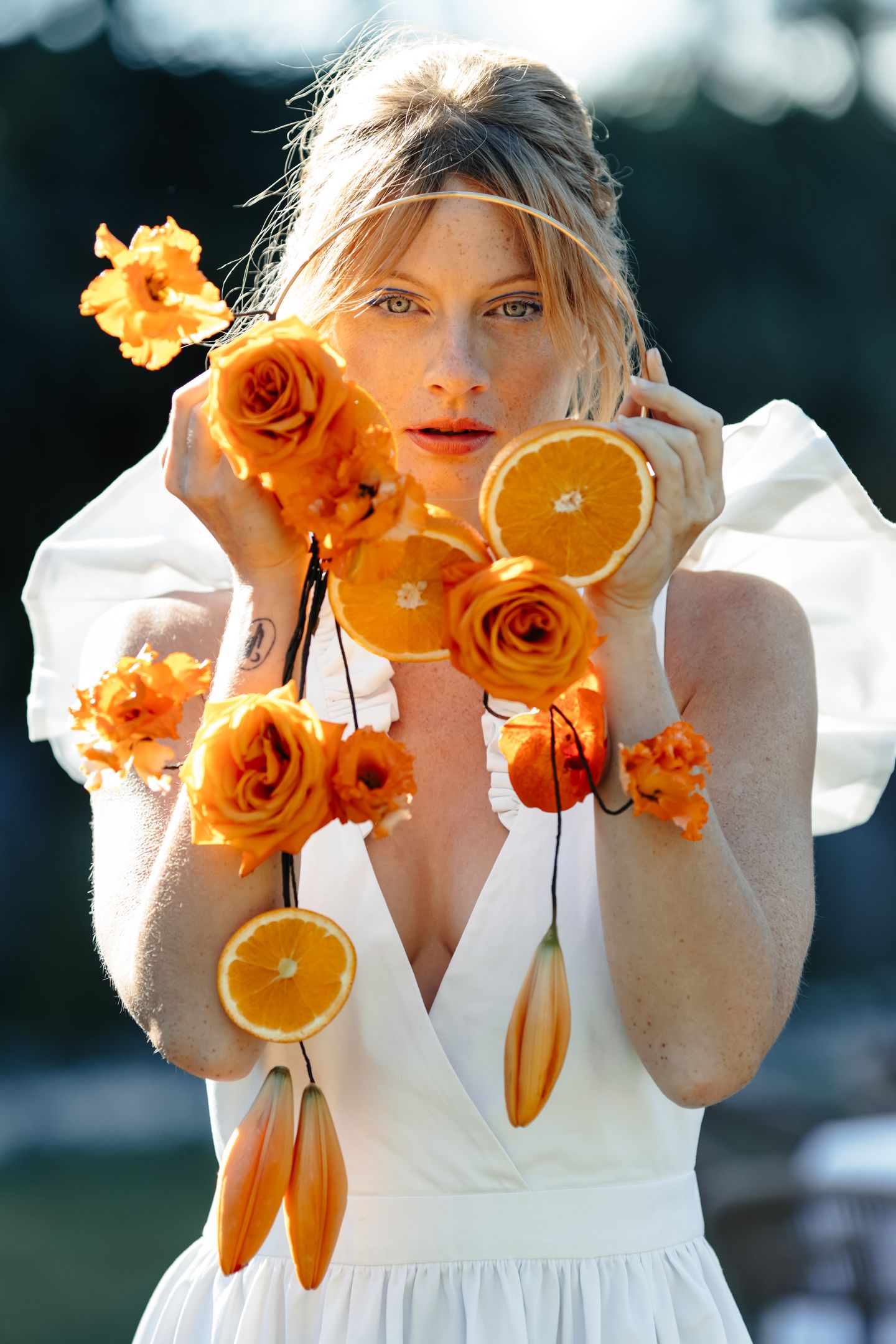 A couple stands outdoors at sunset.