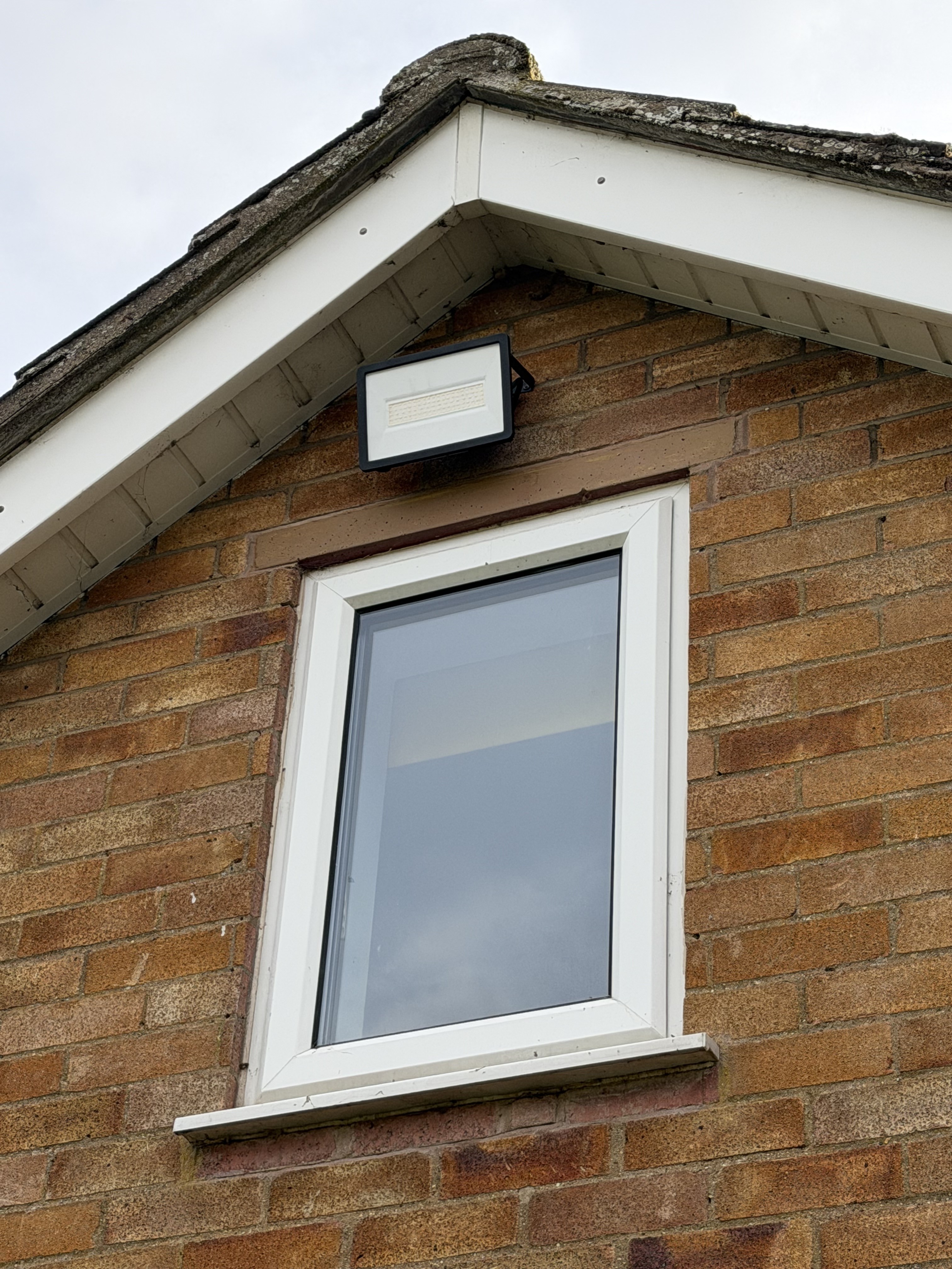 Outdoor floodlight above a window