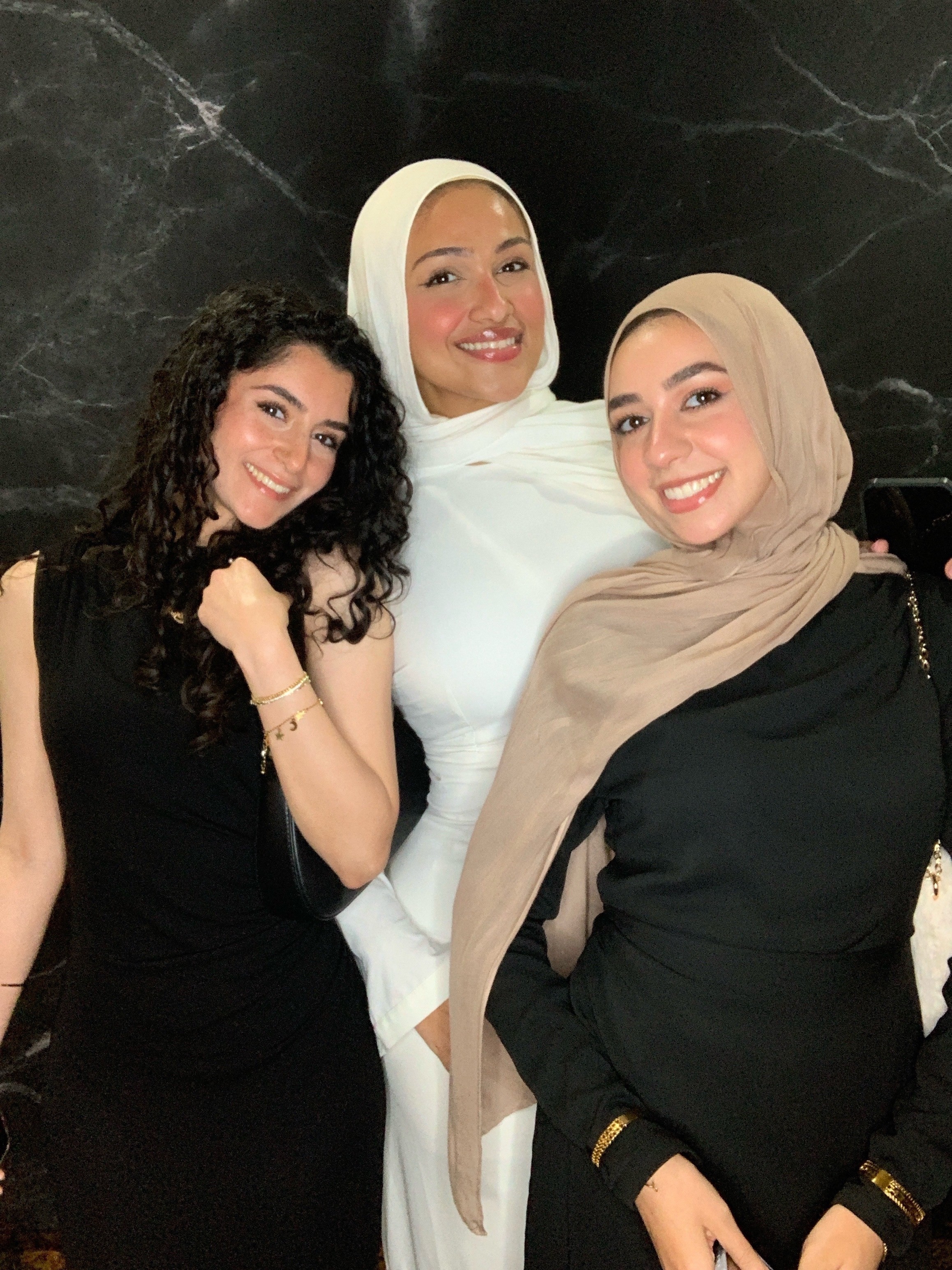 Guest posing at a Layali Booth Co. photo booth backdrop