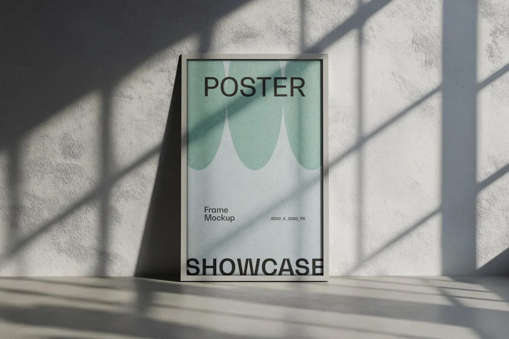 Poster frame mockup leaning against a textured concrete wall, showcasing a modern design with green and black accents. Soft sunlight casts geometric shadows, creating a minimalist aesthetic.
