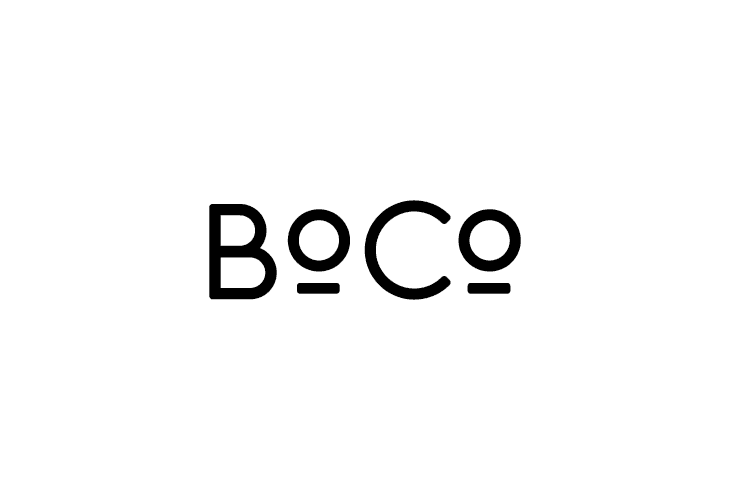 A stylized map of Bogota in yellow with a dark blue play button, surrounded by a white background and a yellow border. The text encourages changing the city one idea at a time, highlighting Boco's role as a platform for innovation and social problem-solving.