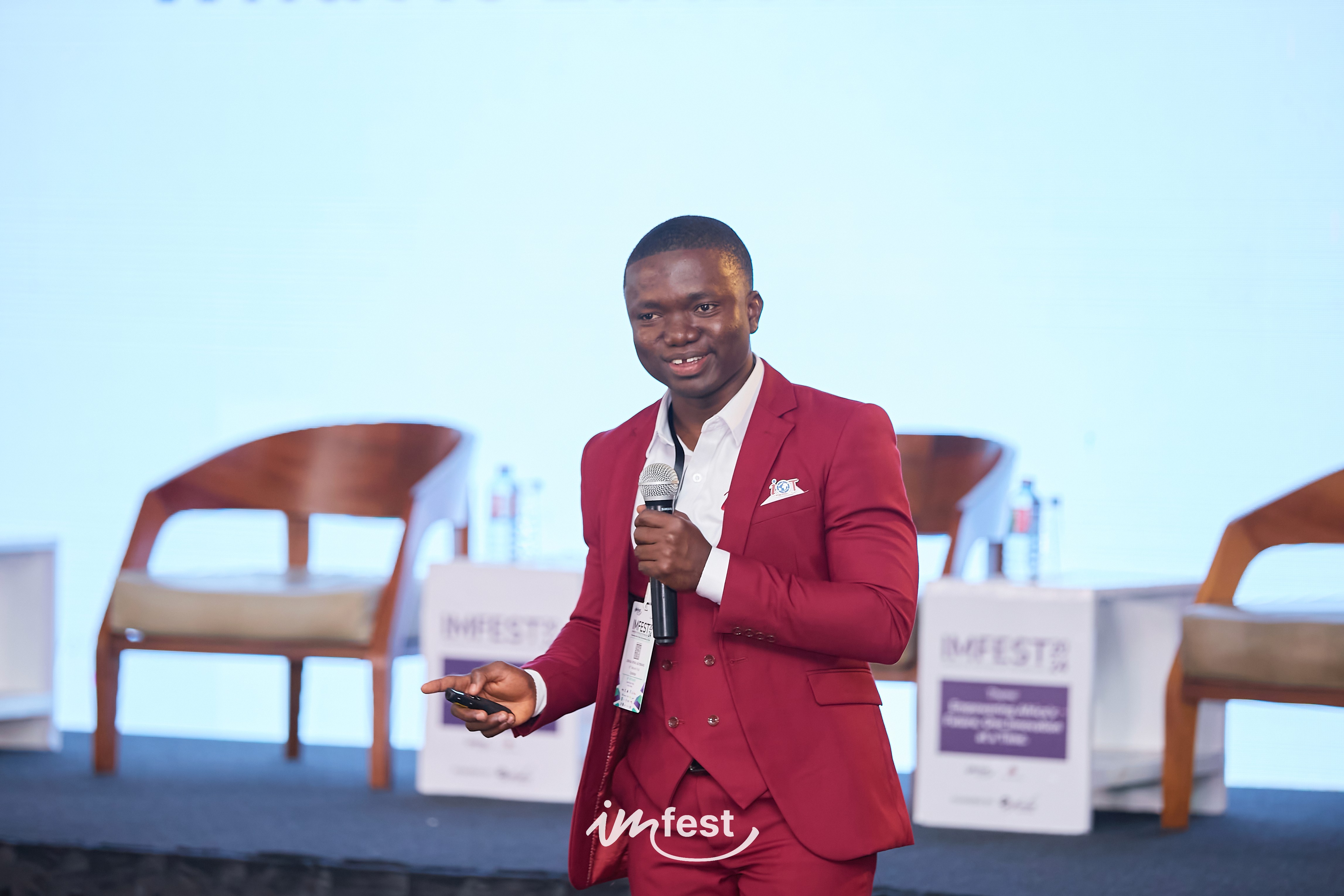 A green butterfly rests on a flower.