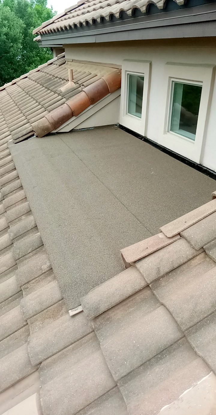 Tile roof repair with modified bitumen flat section. 