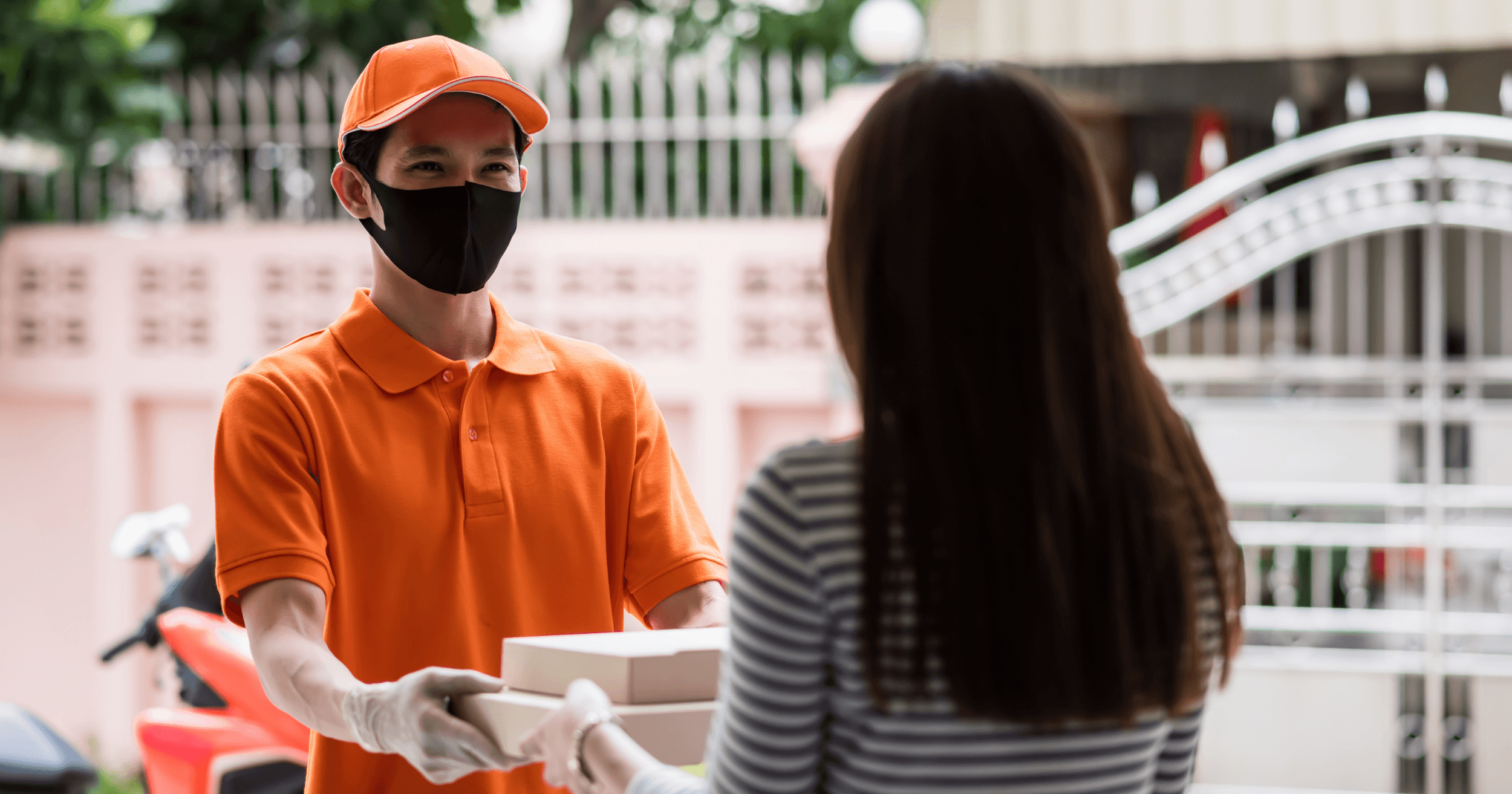 Delivery man handing food to customer