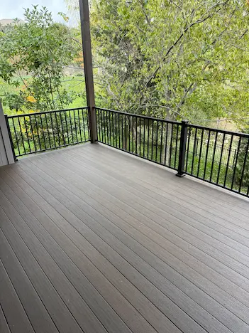 An image of a newly installed deck with neatly laid brown boards.
